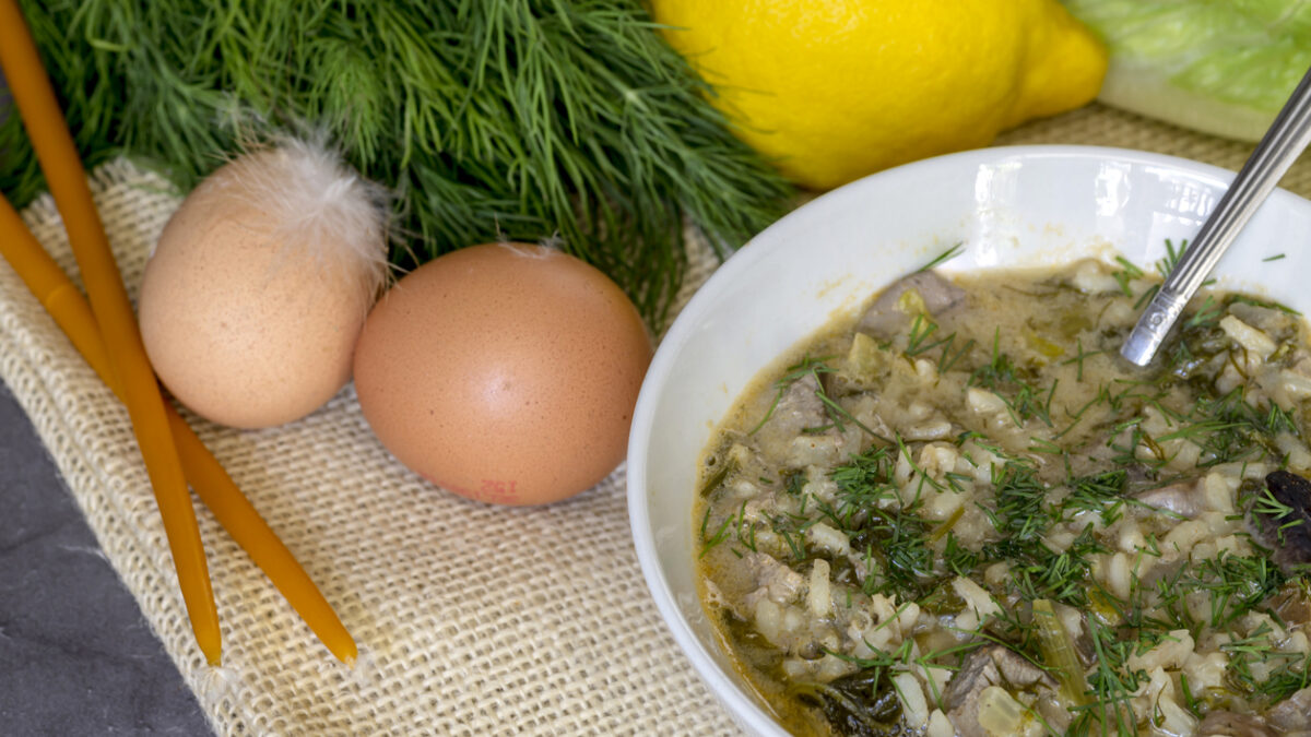 The easter composition. National Greek soup Magiritsa in a bowl, which is prepared once a year on Easter, on a wooden table close-up