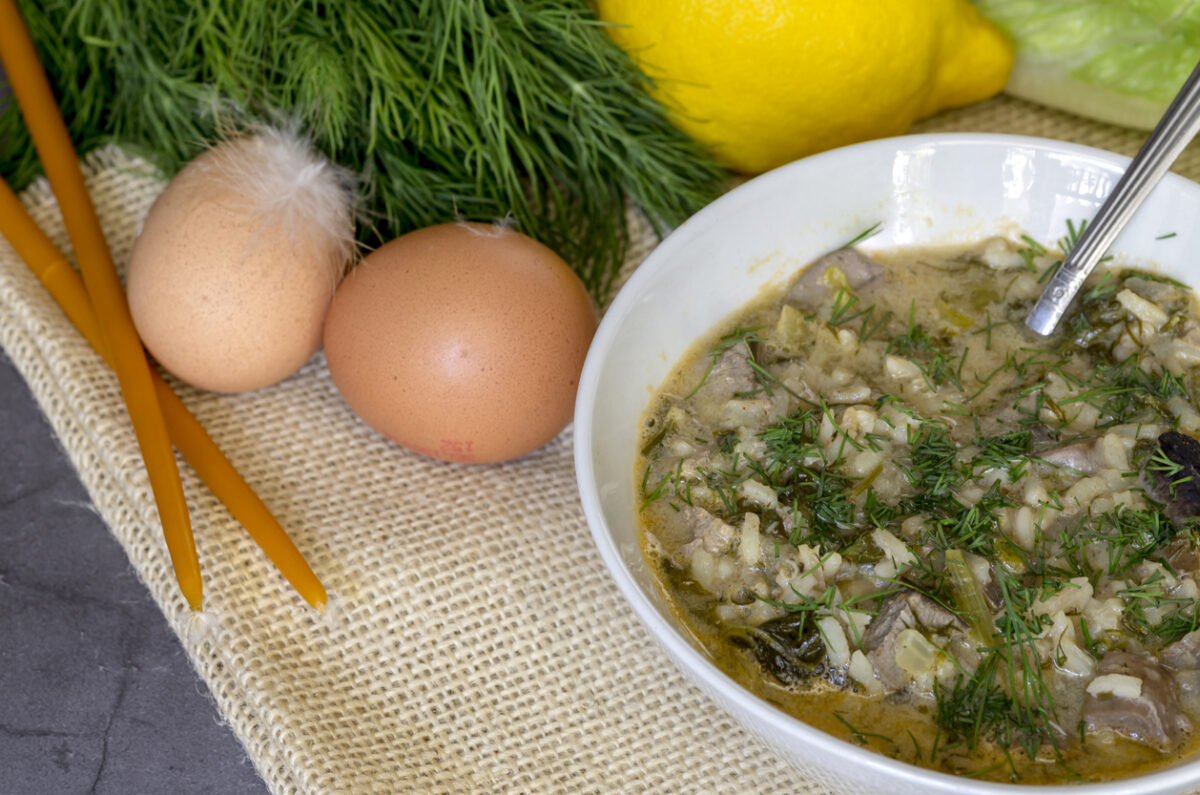 The easter composition. National Greek soup Magiritsa in a bowl, which is prepared once a year on Easter, on a wooden table close-up