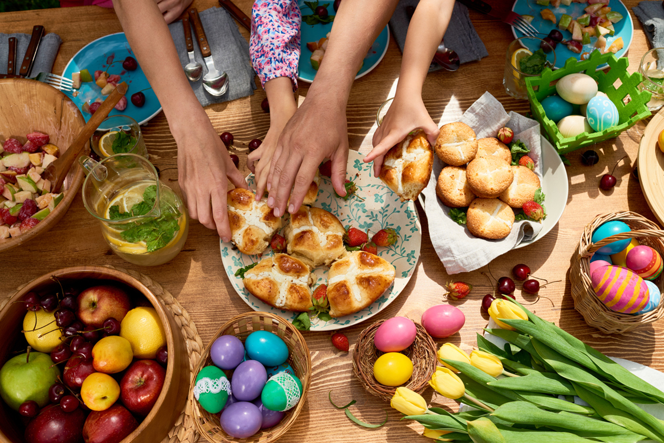 High angle view of family taking sweet buns when they having Easter dinner together