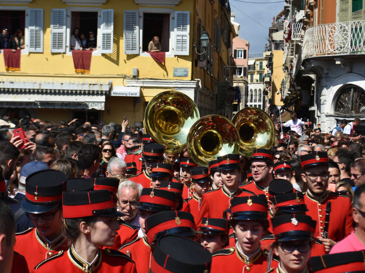 Corfu, Greece - April 15, 2017: The Holly Saturday Procession led by the Corfu marching bands in overcrowded streets of old town of Corfu takes place right after the unique and noisy crashing pottery ceremony