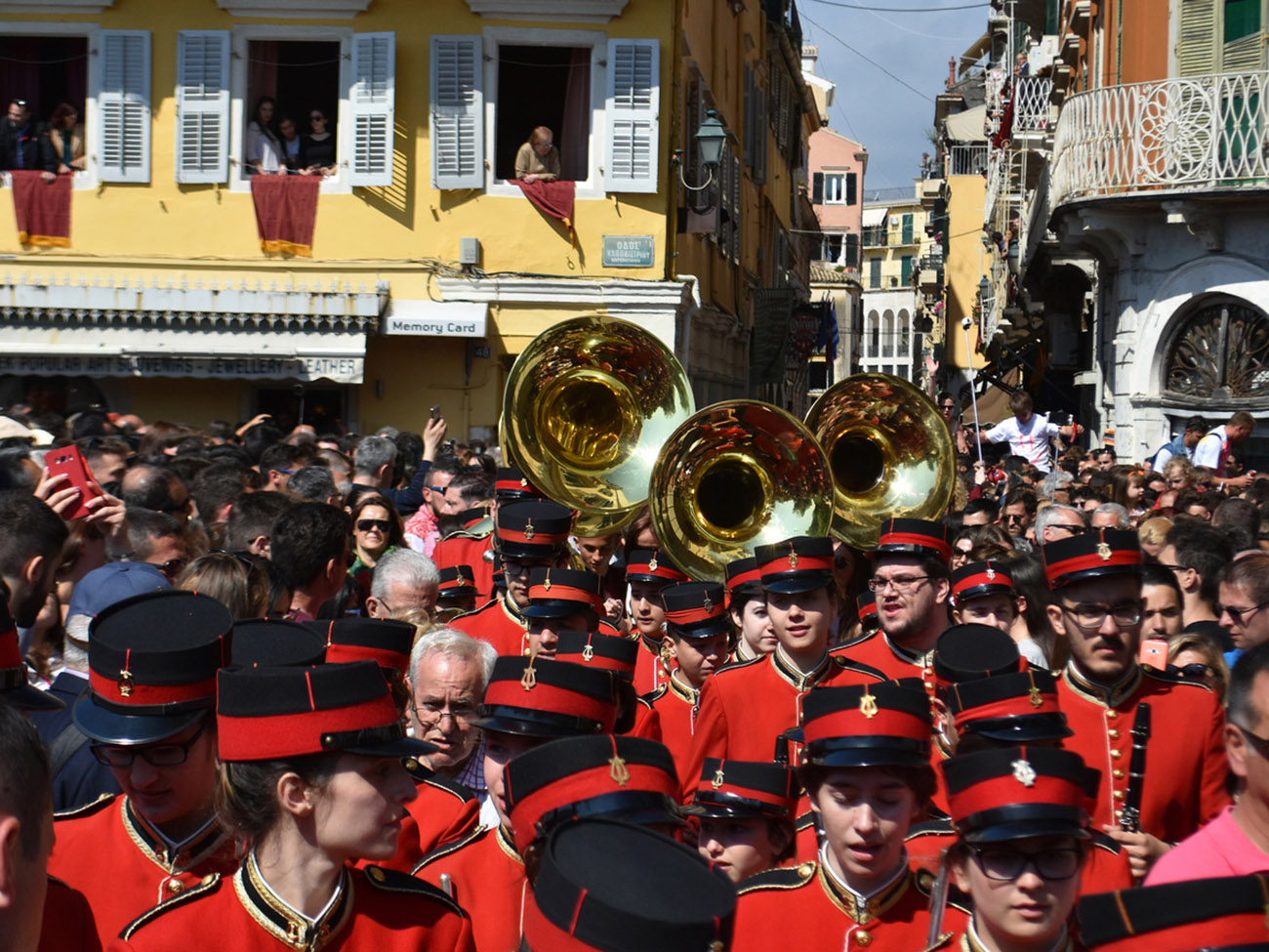 Corfu, Greece - April 15, 2017: The Holly Saturday Procession led by the Corfu marching bands in overcrowded streets of old town of Corfu takes place right after the unique and noisy crashing pottery ceremony