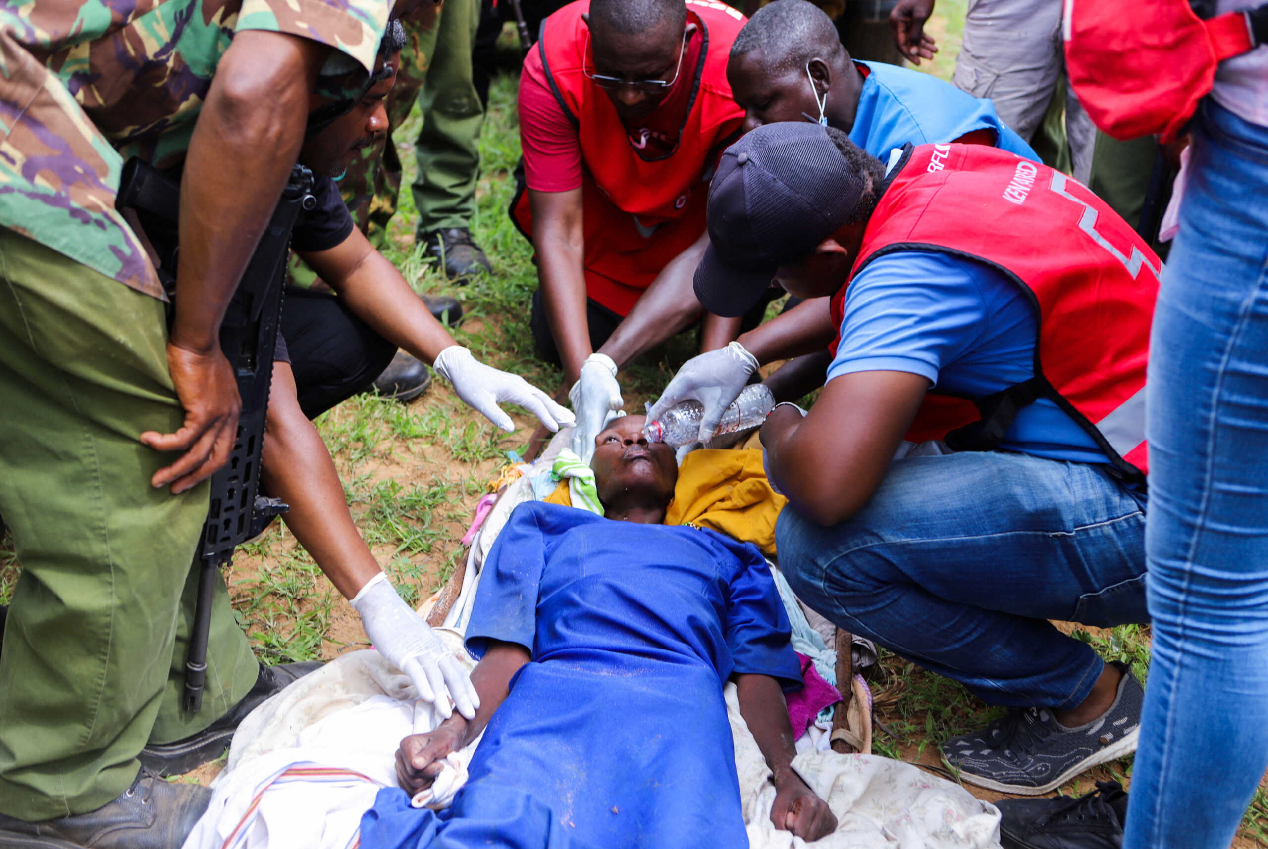Members of the Kenya Red Cross and police officers attend to an emaciated member of a Christian cult named as Good News International Church, whose members believed they would go to heaven if they starved themselves to death, in Shakahola forest of Kilifi county, Kenya April 23, 2023. REUTERS
