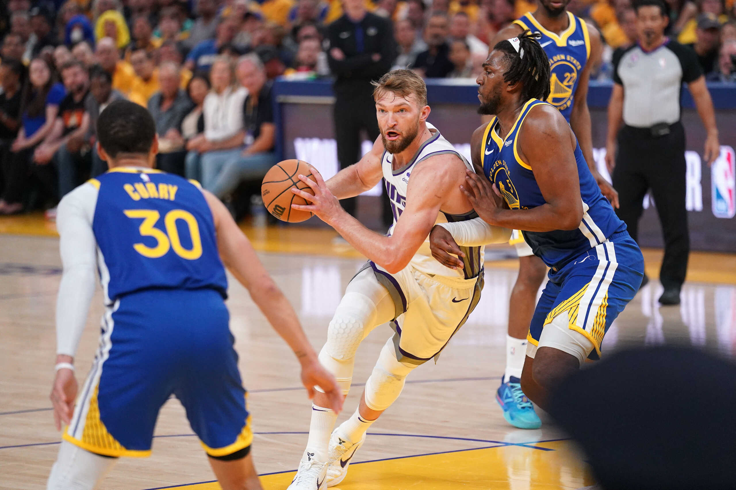Apr 28, 2023; San Francisco, California, USA; Sacramento Kings forward Domantas Sabonis (10) holds onto the ball next to Golden State Warriors forward Kevon Looney (5) in the first quarter during game six of the 2023 NBA playoffs at the Chase Center. Mandatory Credit: Cary Edmondson-USA TODAY Sports