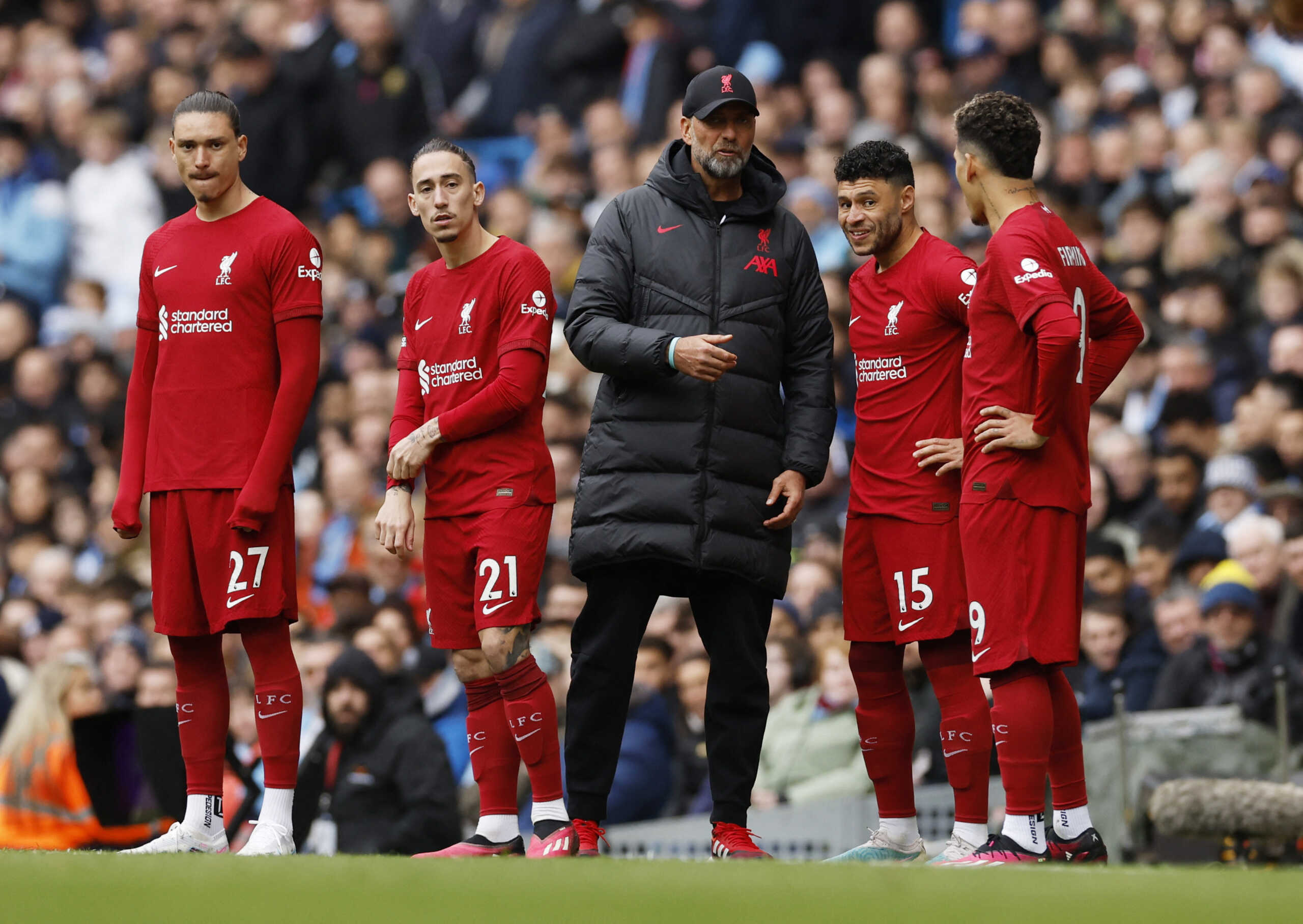 Soccer Football - Premier League - Manchester City v Liverpool - Etihad Stadium, Manchester, Britain - April 1, 2023  Liverpool's Darwin Nunez, Kostas Tsimikas, Alex Oxlade-Chamberlain and Roberto Firmino receive instructions from manager Juergen Klopp as they prepare to come on as substitutes Action Images via Reuters
