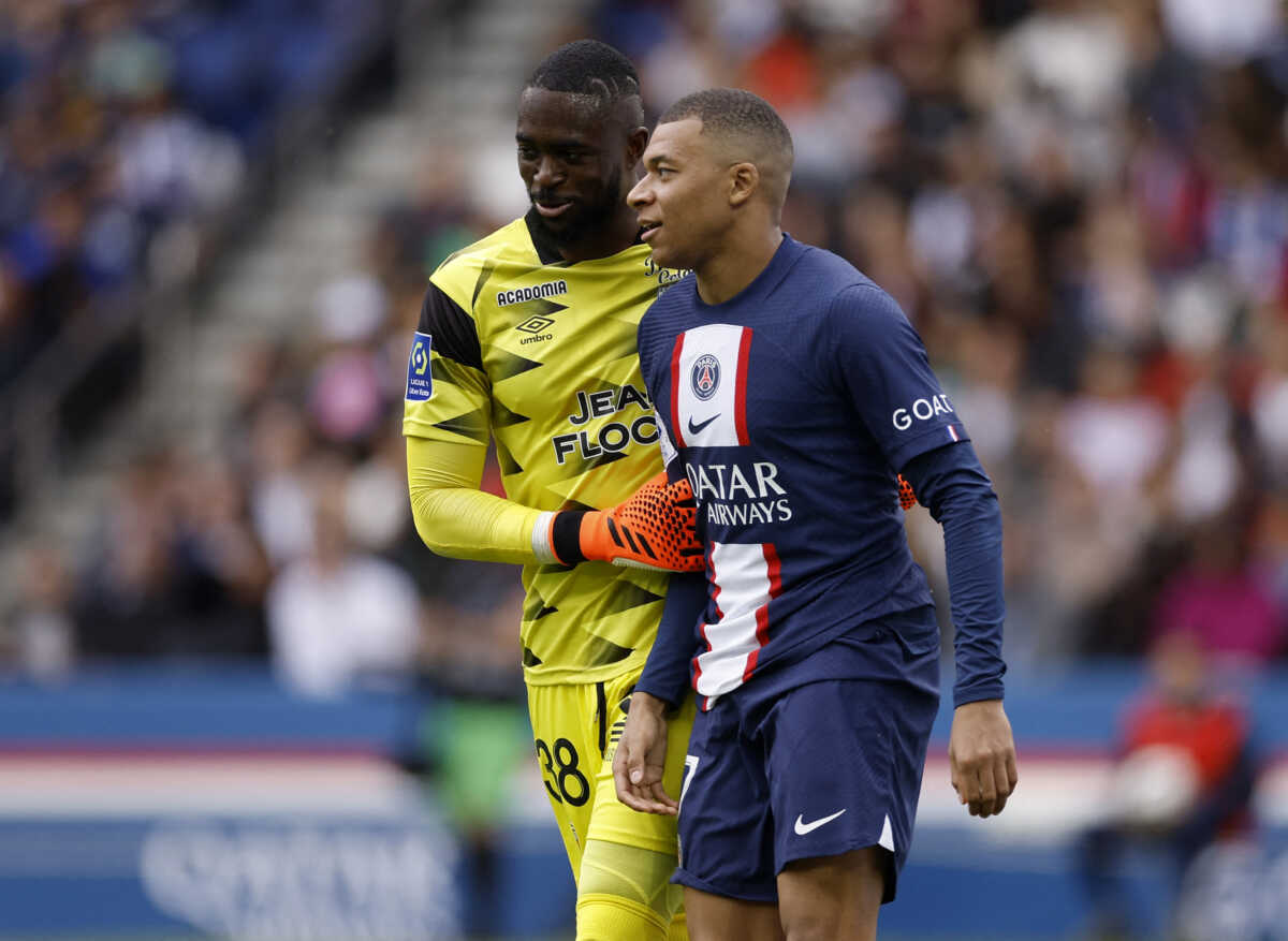 Soccer Football - Ligue 1 - Paris St Germain v Lorient - Parc des Princes, Paris, France - April 30, 2023 FC Lorient's Yvon Mvogo and Paris St Germain's Kylian Mbappe REUTERS