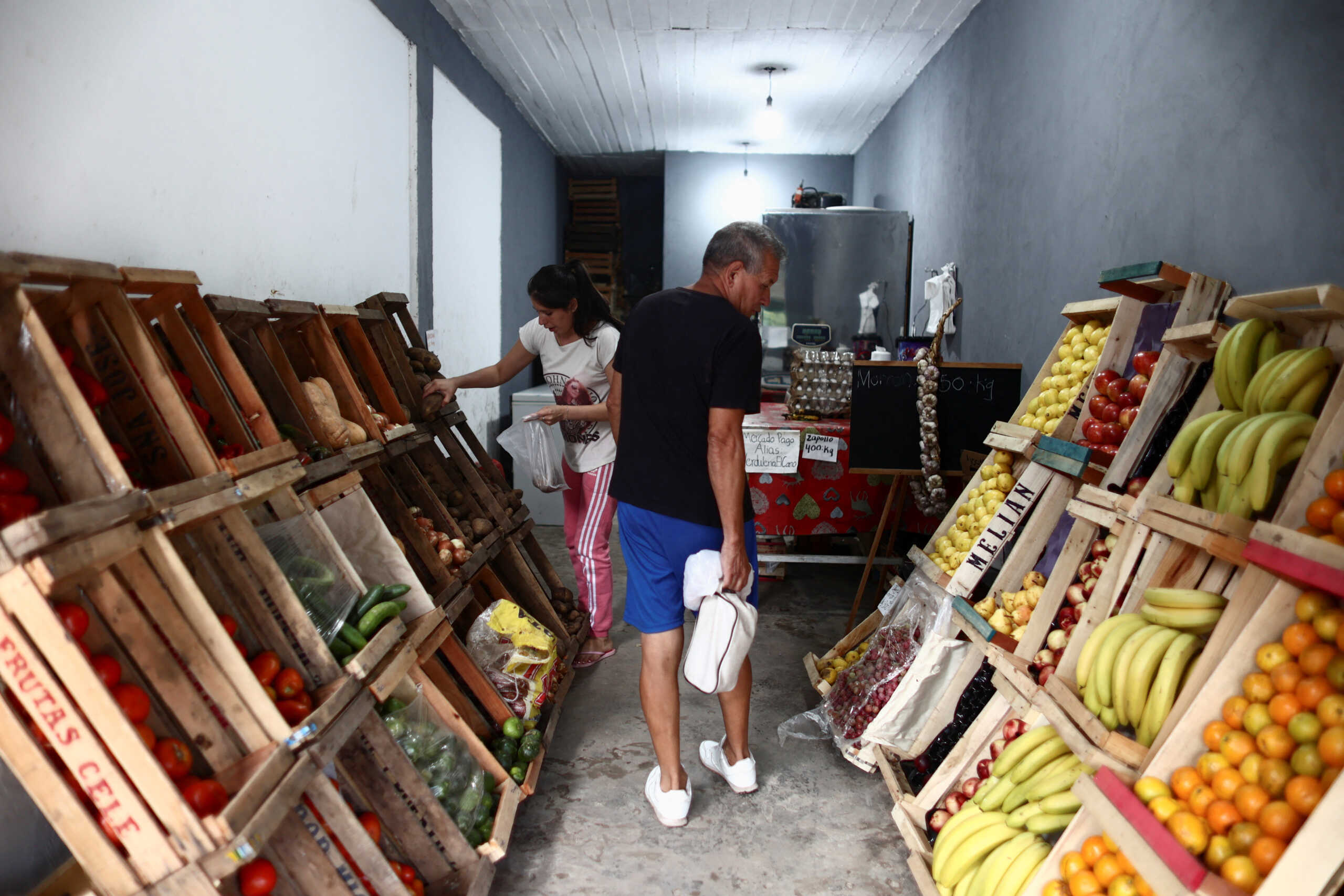Jorge Pedro Armoa, 67, looks for vegetables in a grocery store after working in one of his three jobs to beat Argentina's over 100% inflation rate, in 9 de Abril, in the outskirts of Buenos Aires, Argentina March 22, 2023. REUTERS