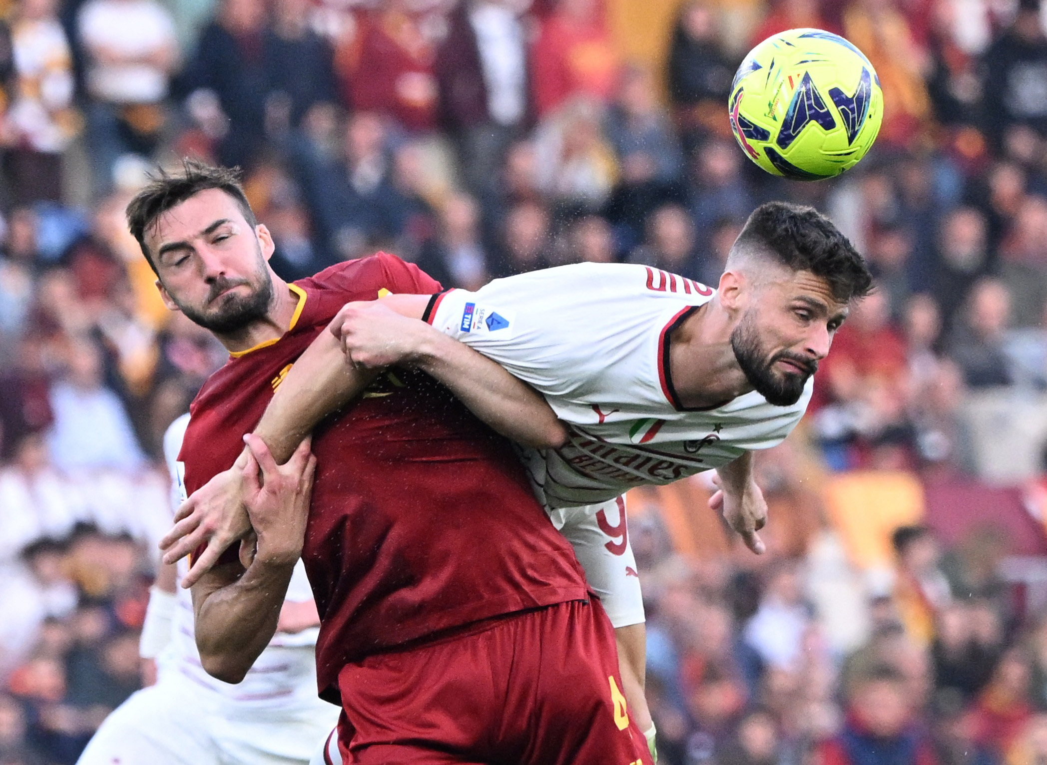 Soccer Football - Serie A - AS Roma v AC Milan - Stadio Olimpico, Rome, Italy - April 29, 2023 AC Milan's Olivier Giroud in action with AS Roma's Bryan Cristante REUTERS