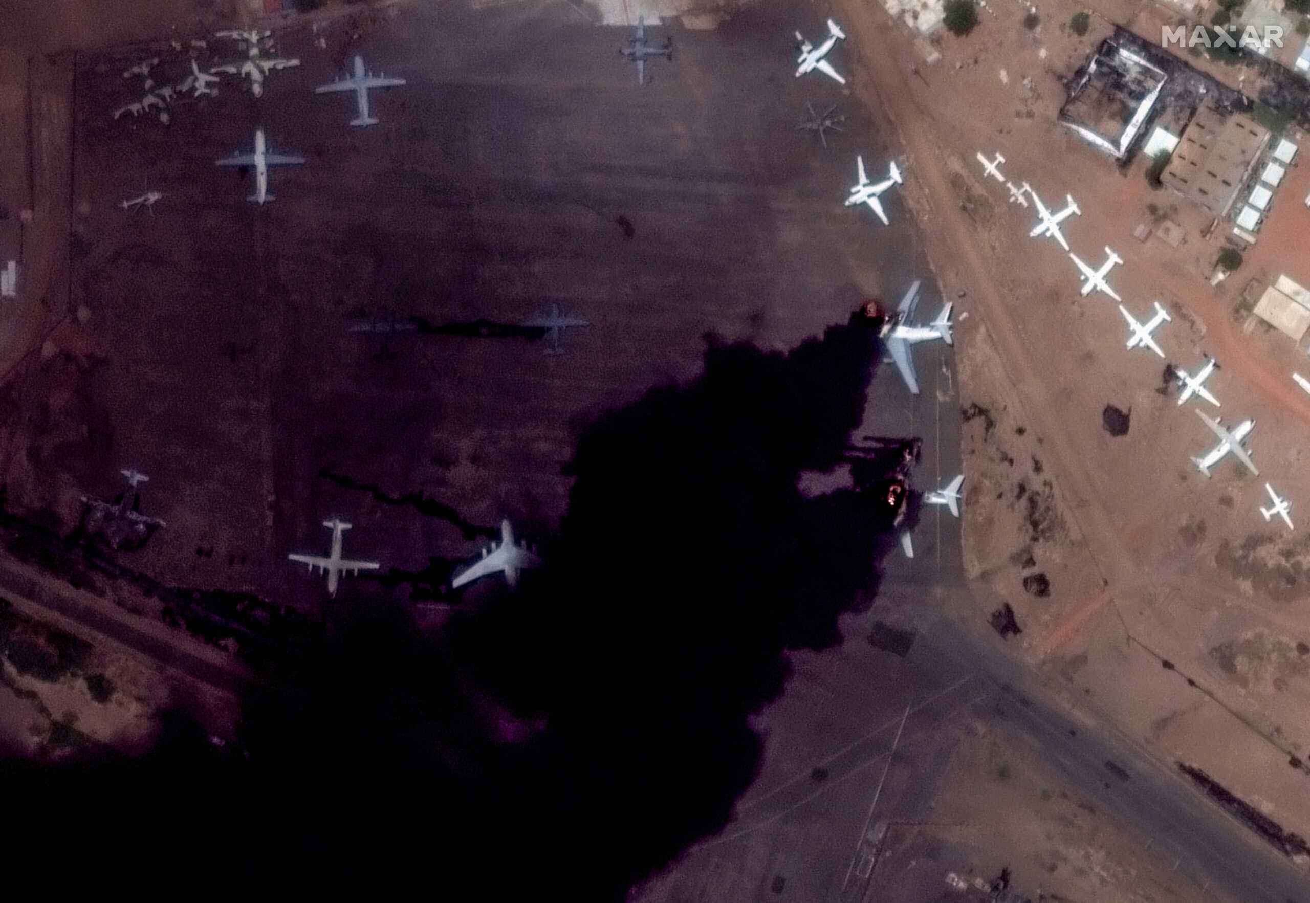 Satellite image shows burning IL-76 candid airplanes at Khartoum International Airport in Khartoum, Sudan April 16, 2023, in this handout image. Courtesy of Maxar Technologies