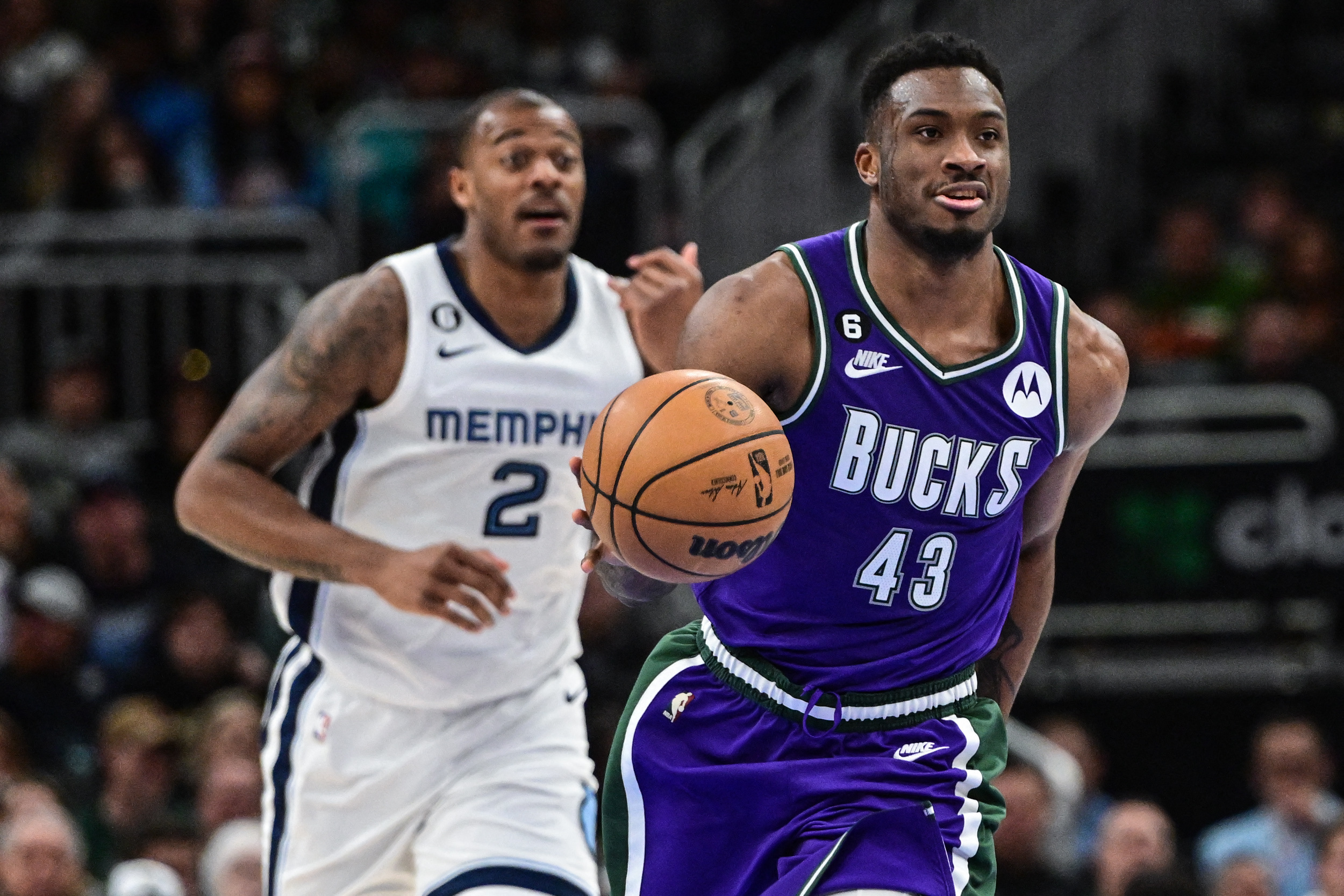 Apr 7, 2023; Milwaukee, Wisconsin, USA; Milwaukee Bucks forward Thanasis Antetokounmpo (43) brings the ball down court in front of Memphis Grizzlies forward Xavier Tillman (2) in the third quarter at Fiserv Forum. Mandatory Credit: Benny Sieu-USA TODAY Sports