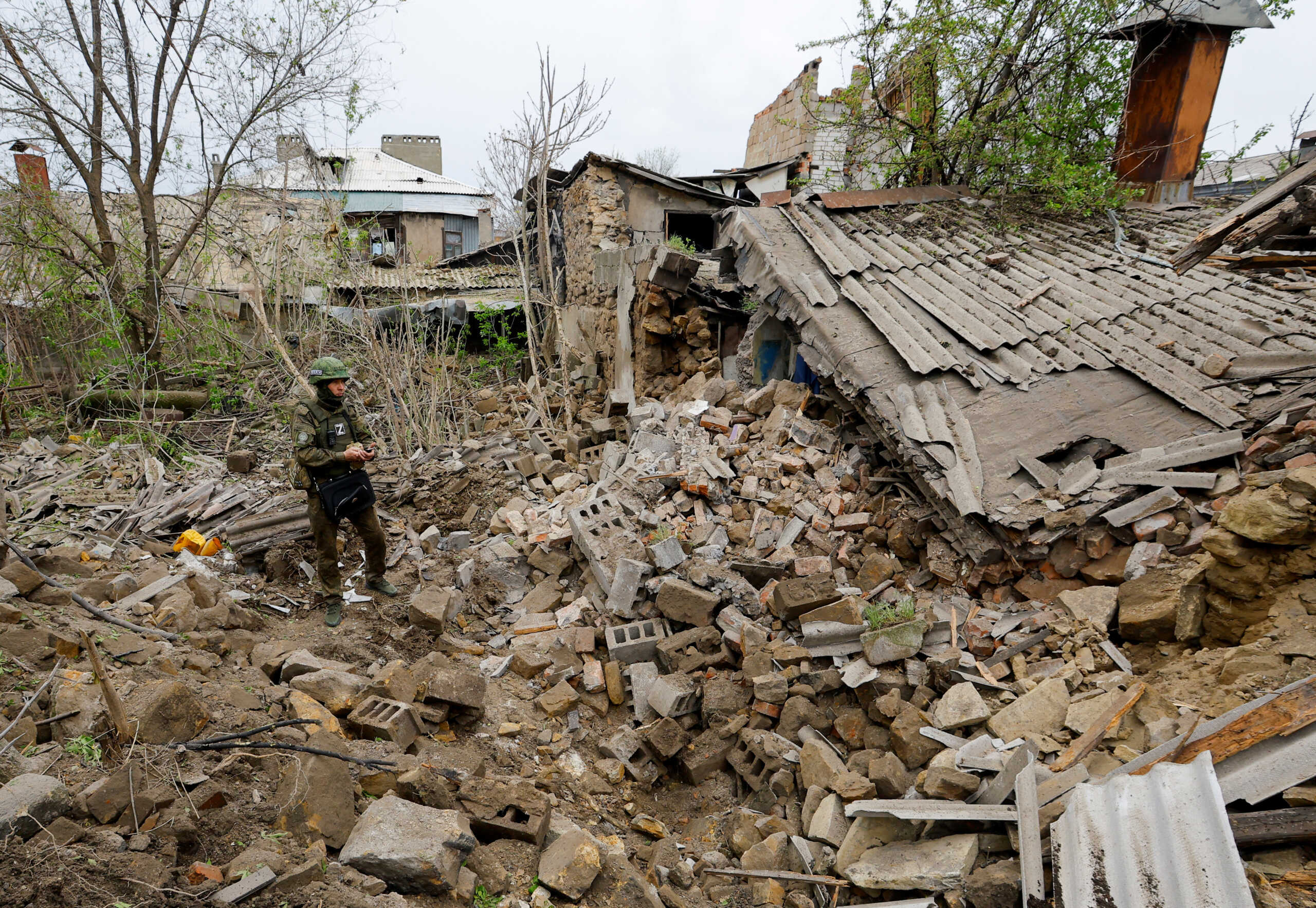 A Russian military investigator inspects the rubble of a house destroyed by recent shelling in the course of Russia-Ukraine conflict in Donetsk, Russian-controlled Ukraine, April 28, 2023. REUTERS