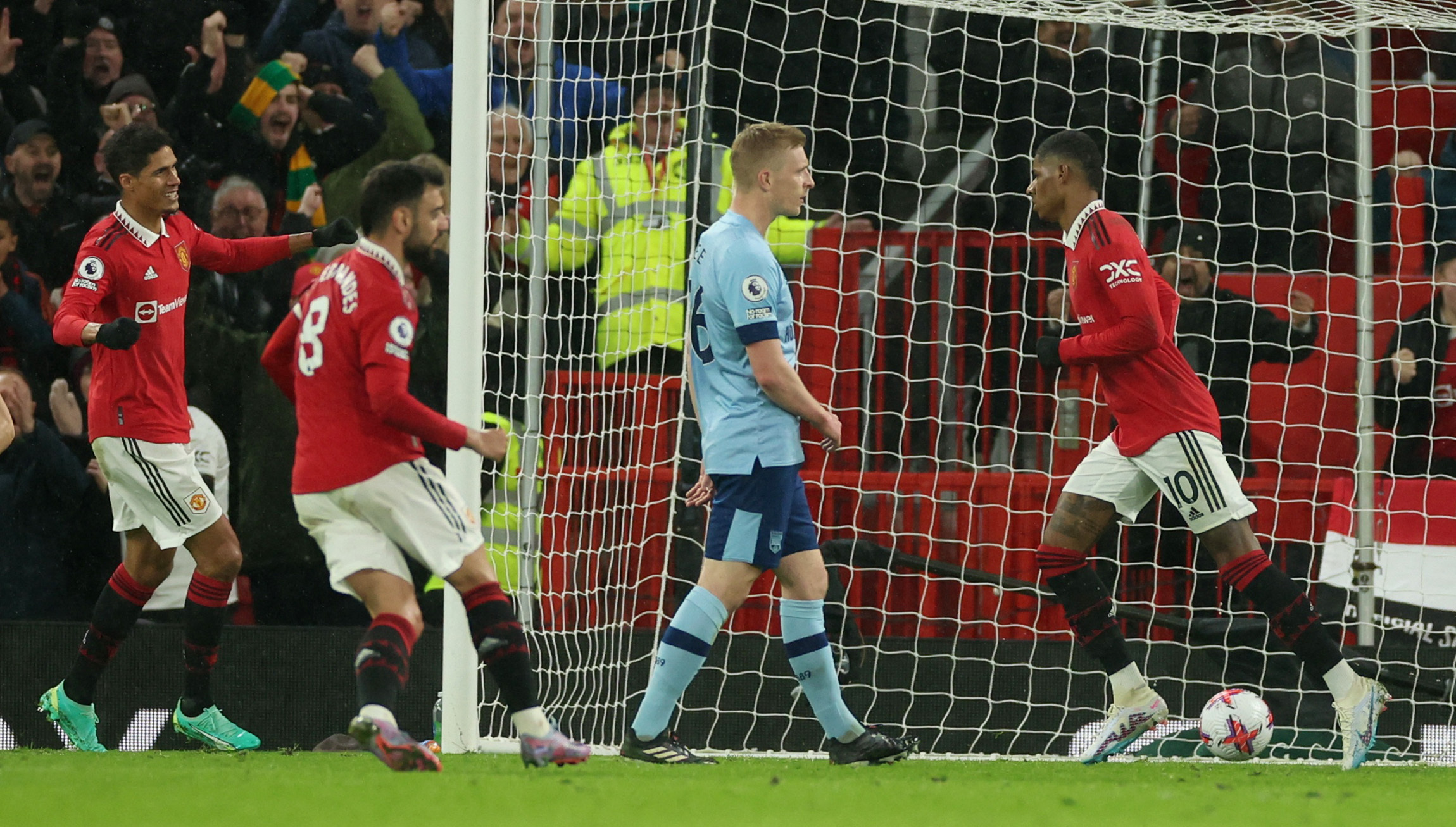 Soccer Football - Premier League - Manchester United v Brentford - Old Trafford, Manchester, Britain - April 5, 2023 Manchester United's Marcus Rashford celebrates scoring their first goal with Raphael Varane and Bruno Fernandes REUTERS