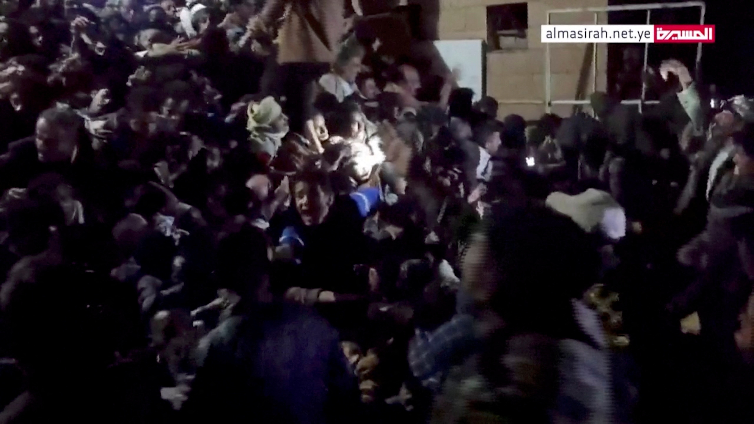 People trapped in the crowd attempt to free themselves during a stampede in Sanaa, Yemen, April 19, 2023, in this still image taken from video.  Al Masirah TV