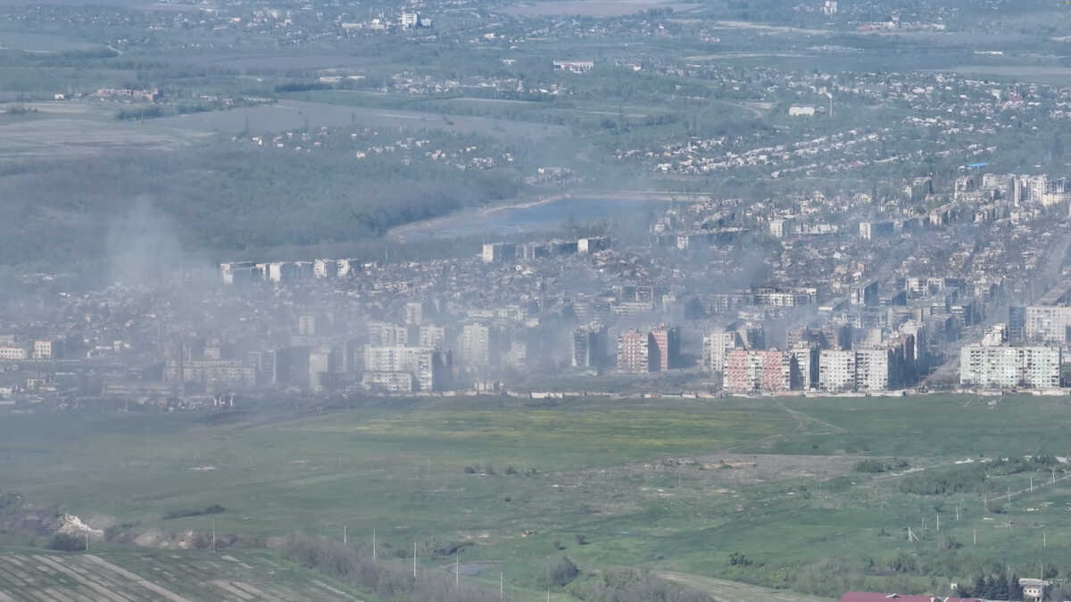 Smoke erupts following a shell explosion, amid Russia's attack on Ukraine, in Bakhmut, Donetsk region, Ukraine in this screengrab obtained from a handout video released on May 7, 2023. Adam Tactic Group