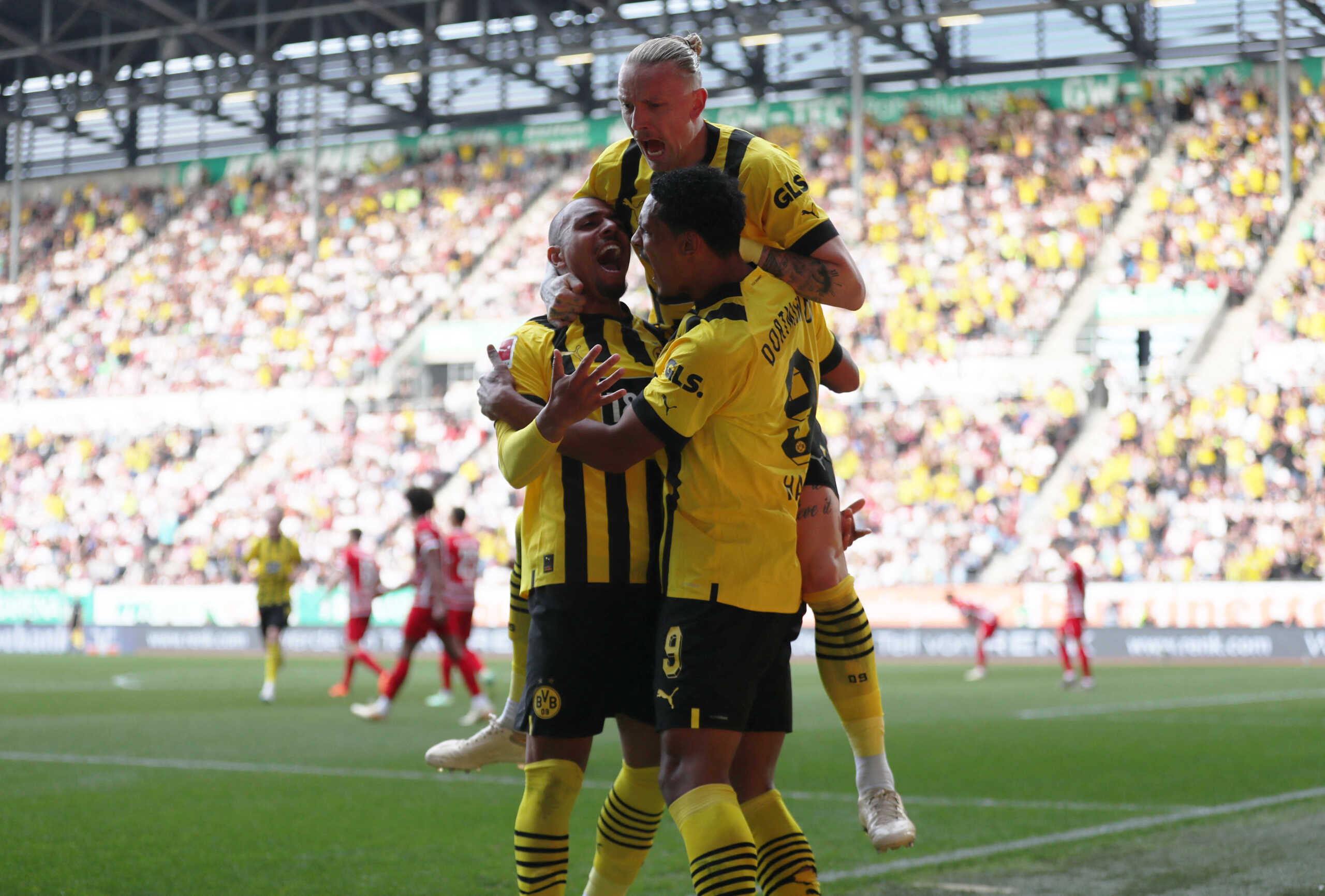 Soccer Football - Bundesliga - FC Augsburg v Borussia Dortmund - WWK Arena, Augsburg, Germany - May 21, 2023 Borussia Dortmund's Sebastien Haller celebrates scoring their first goal with Donyell Malen and Marius Wolf REUTERS