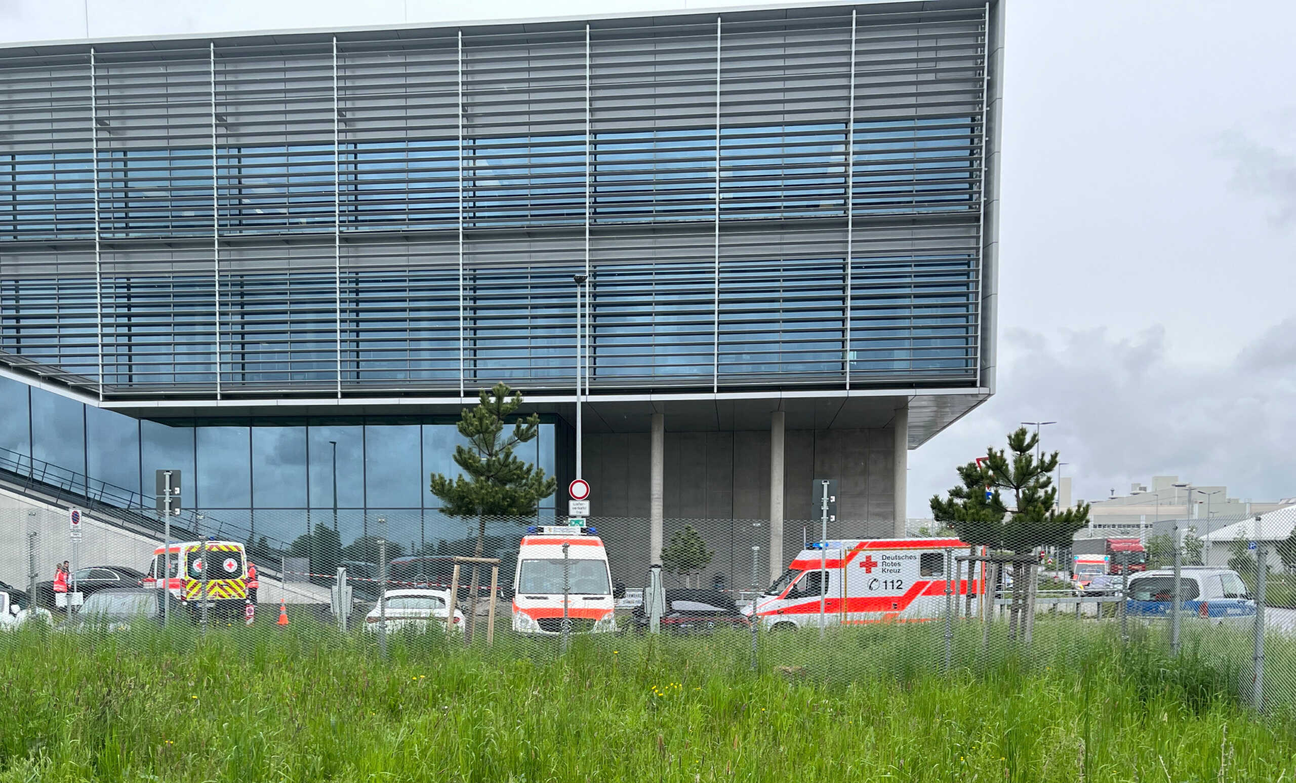 Ambulance cars are parked outside a Mercedes plant after a suspect was detained following a shooting at a Mercedes-Benz plant in Sindelfingen near Stuttgart, Germany, May 11, 2023.     REUTERS