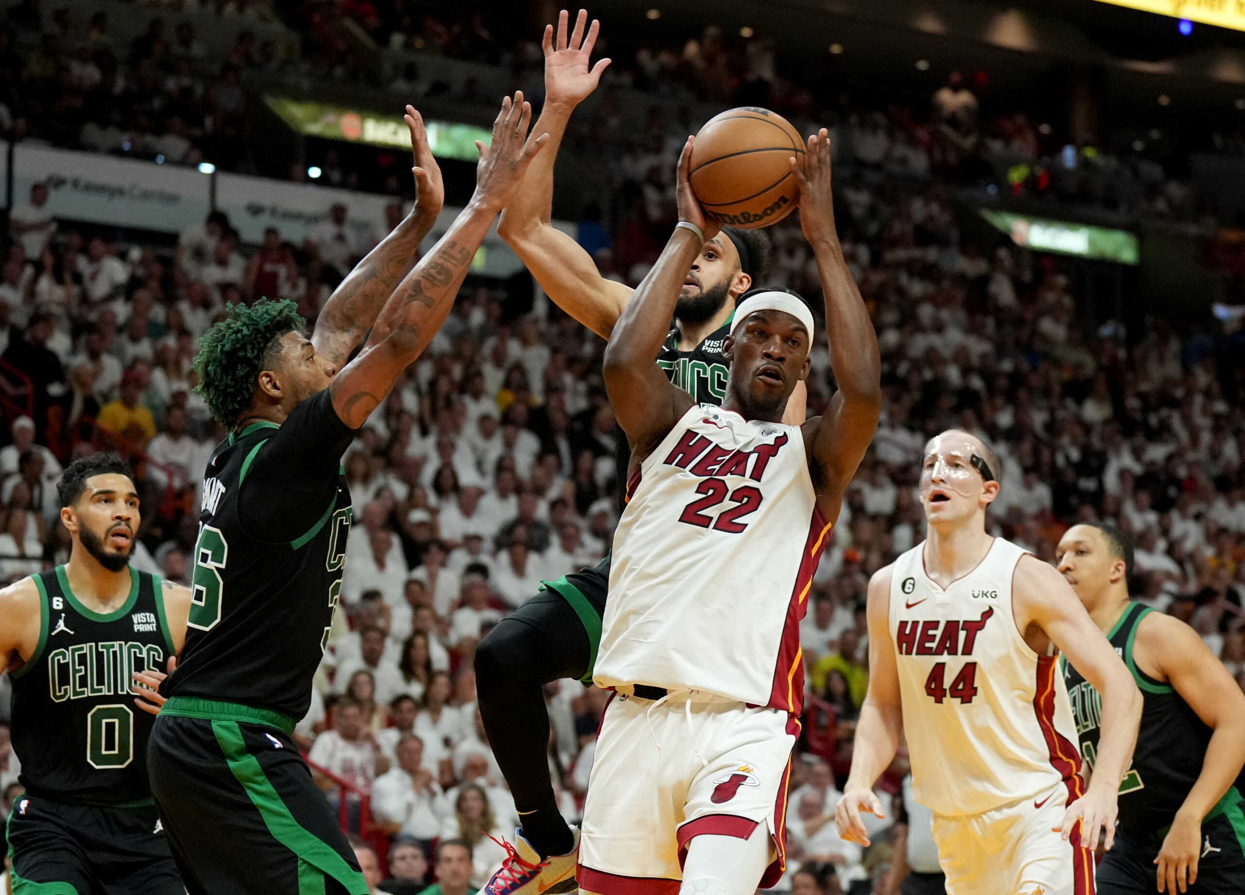 May 21, 2023; Miami, Florida, USA; Miami Heat forward Jimmy Butler (22) passes against Boston Celtics guard Marcus Smart (36) during the first half in game three of the Eastern Conference Finals for the 2023 NBA playoffs at Kaseya Center. Mandatory Credit: Jim Rassol-USA TODAY Sports