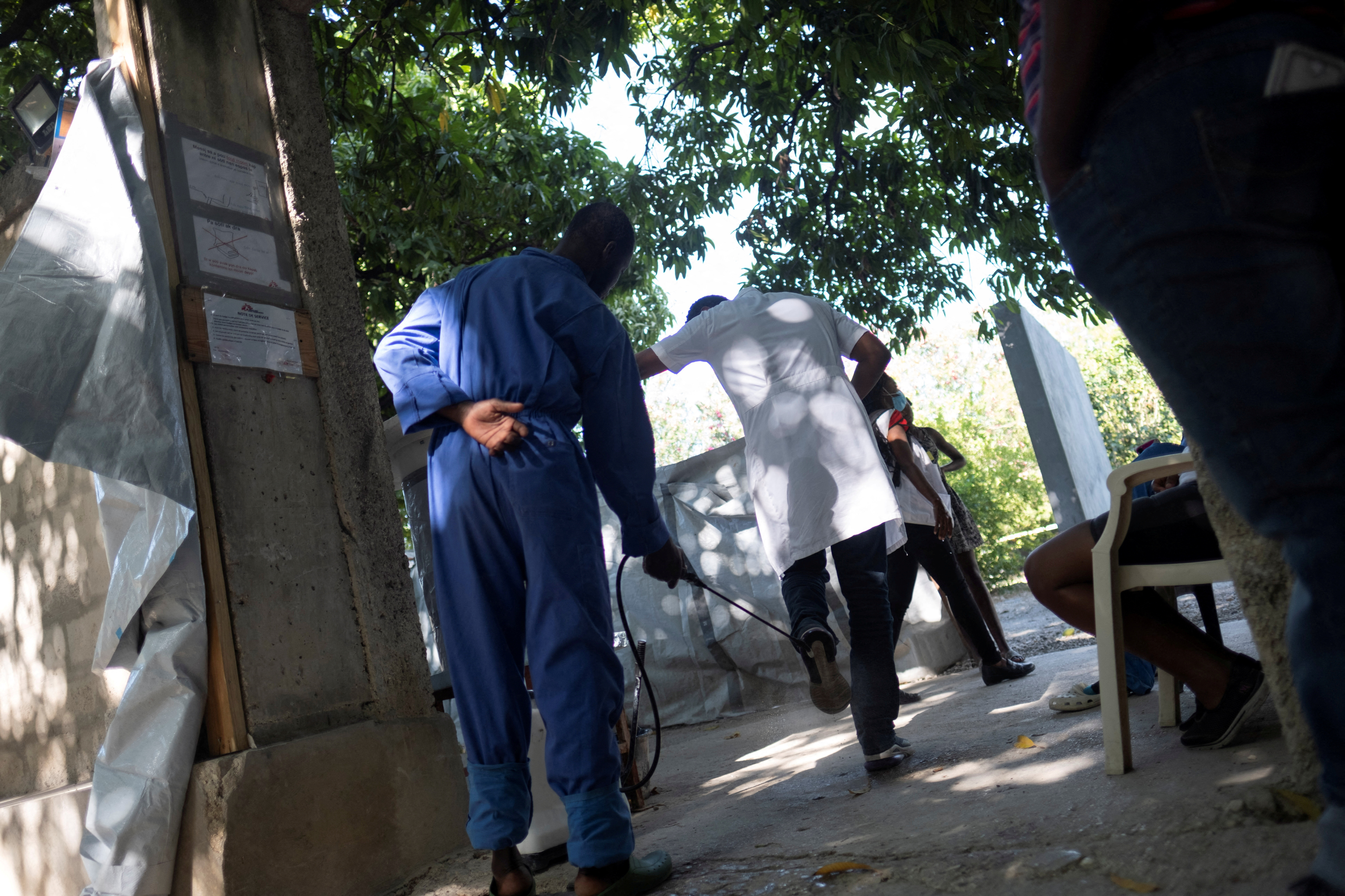 FILE PHOTO: A medical personnel disinfects a colleague at the exit of the cholera ward at a clinic run by Doctors Without Borders in the Cite Soleil neighborhood days in Port-au-Prince, Haiti February 3,2023. REUTERS