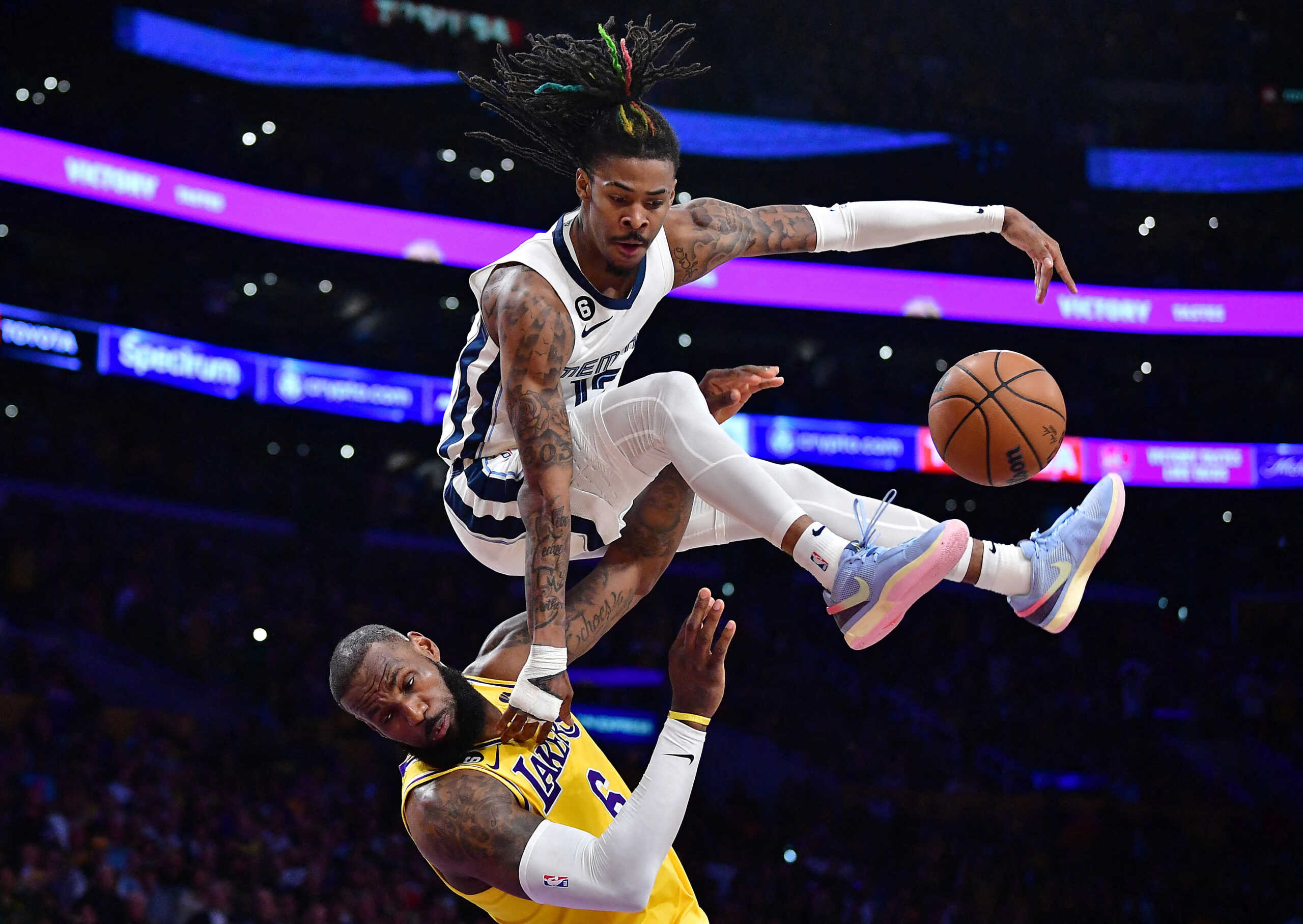 Apr 24, 2023; Los Angeles, California, USA; Memphis Grizzlies guard Ja Morant (12) collides with Los Angeles Lakers forward LeBron James (6) while moving to the basket during the second half in game four of the 2023 NBA playoffs at Crypto.com Arena. Mandatory Credit: Gary A. Vasquez-USA TODAY Sports     TPX IMAGES OF THE DAY