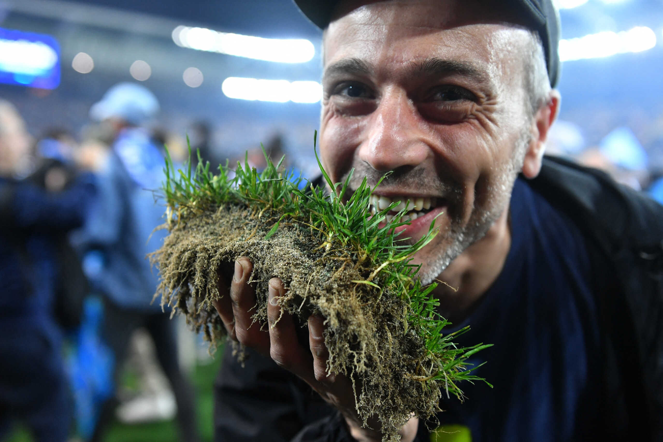 Soccer Football - Serie A - Udinese v Napoli - Dacia Arena, Udine, Italy - May 4, 2023 A Napoli fan celebrates winning Serie A on the pitch after the match REUTERS