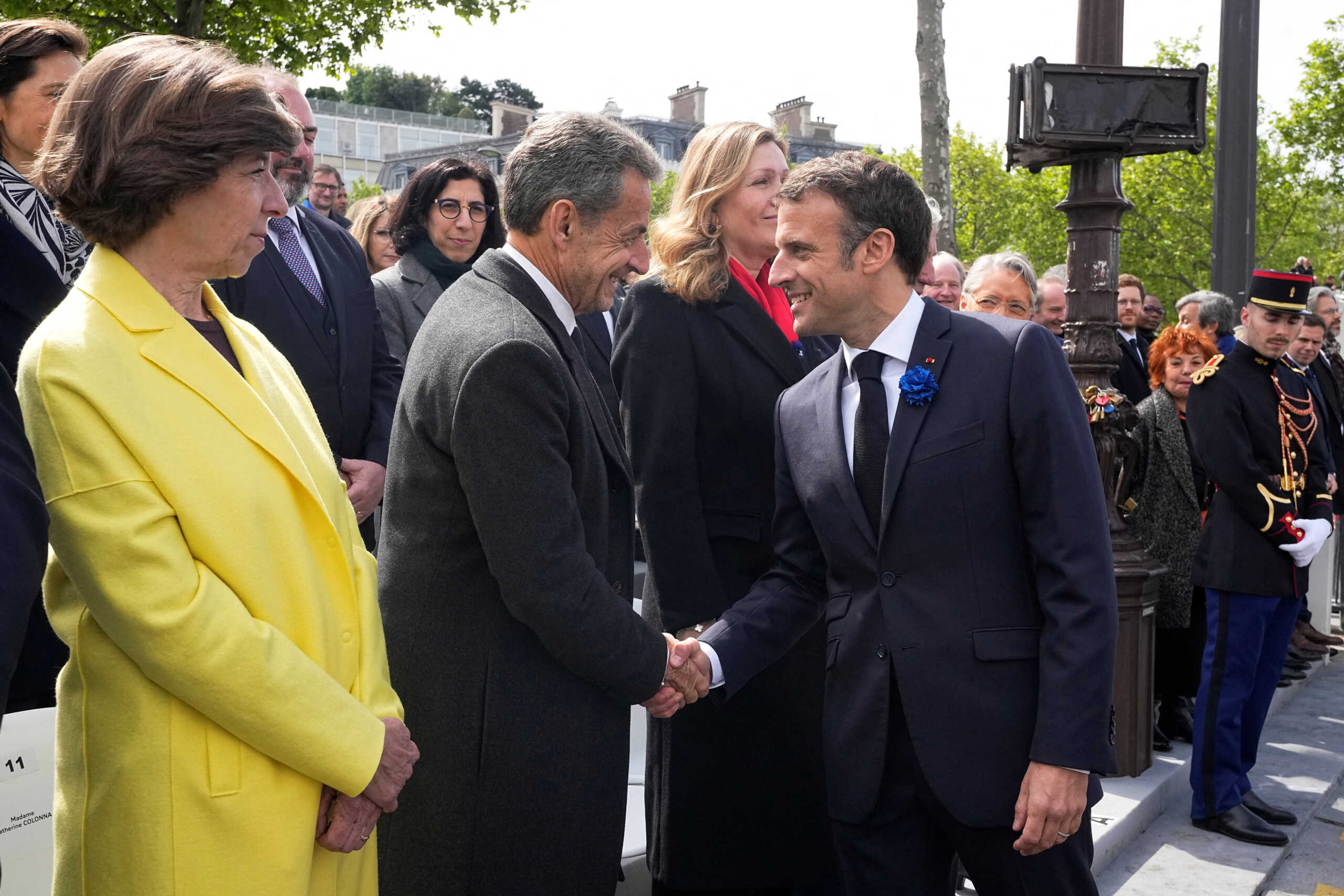 French President Emmanuel Macron shakes hands with former French President Nicolas Sarkozy as French Foreign Minister Catherine Colonna looks on during ceremonies commemorating the end of World War II anniversary (Victory Day), Monday, May 8, 2023 in Paris, France. Michel Euler