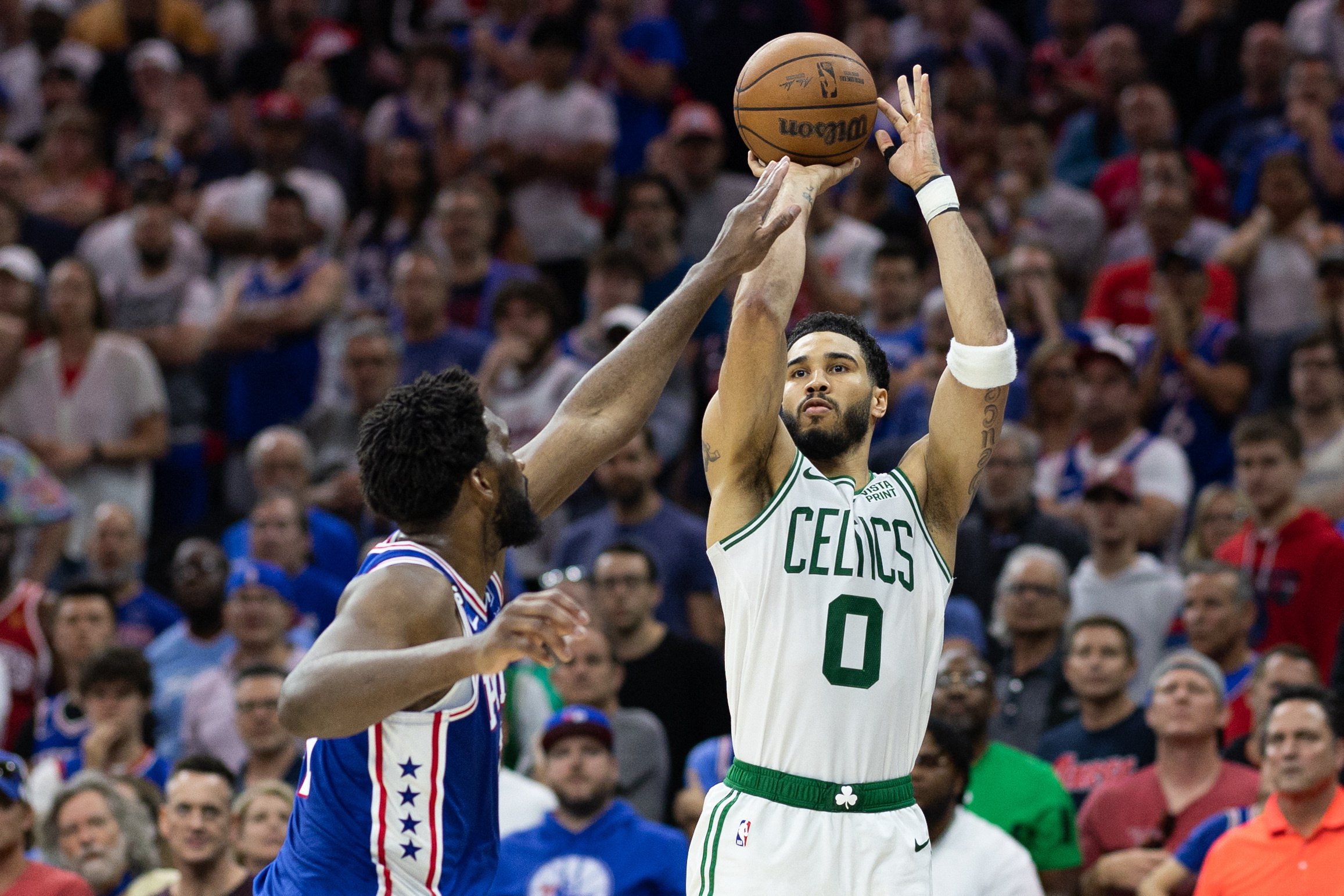 May 11, 2023; Philadelphia, Pennsylvania, USA; Boston Celtics forward Jayson Tatum (0) shoots the ball past Philadelphia 76ers center Joel Embiid (21) during the fourth quarter in game six of the 2023 NBA playoffs at Wells Fargo Center. Mandatory Credit: Bill Streicher-USA TODAY Sports