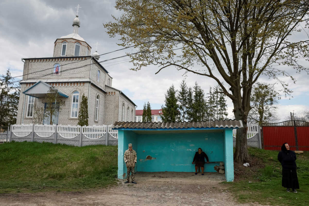 Supporters and opponents of their village's church switch from the Ukrainian Orthodox Church (UOC) to the Orthodox Church of Ukraine (OCU) are seen, amid Russia's attack on Ukraine, in the village of Karyshkiv, Vinnytsia region, Ukraine April 22, 2023. REUTERS