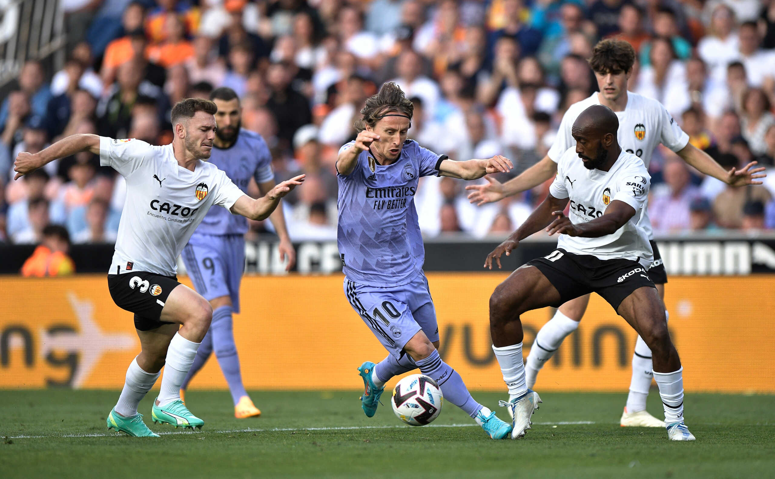 Soccer Football - LaLiga - Valencia v Real Madrid - Mestalla, Valencia, Spain - May 21, 2023 Real Madrid's Luka Modric in action with Valencia's Dimitri Foulquier and Toni Lato REUTERS