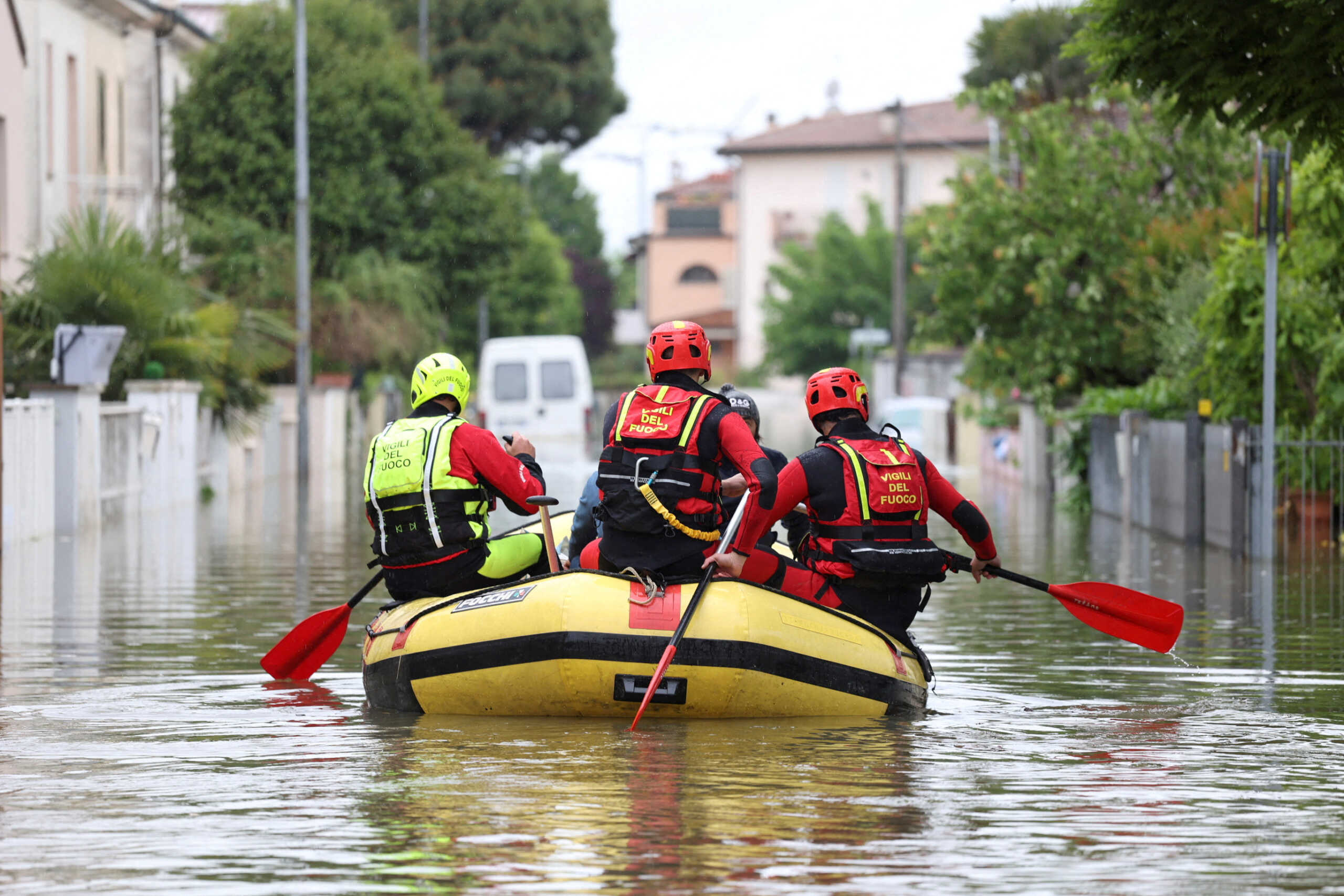 FILE PHOTO: Firefighters transport food and water to people who are still in their homes after heavy rains hit Italy's Emilia Romagna region, in Lugo, Italy, May 19, 2023. REUTERS