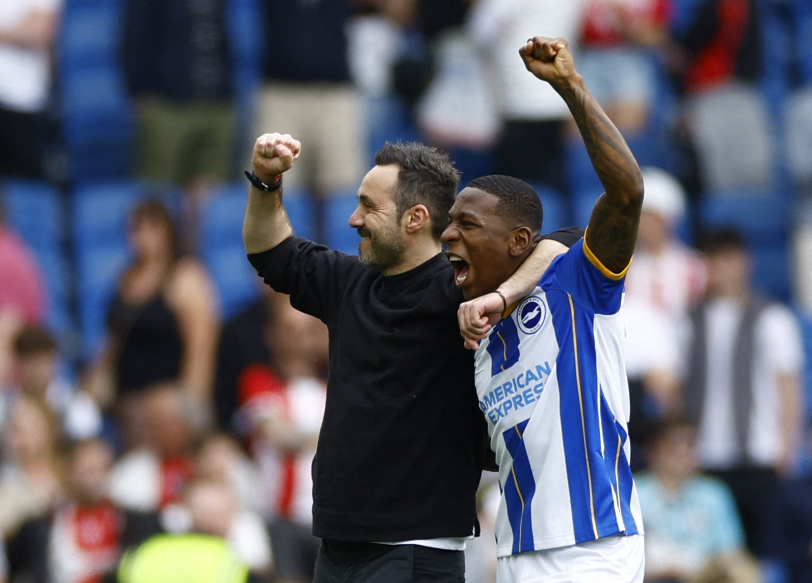Soccer Football - Premier League - Brighton & Hove Albion v Southampton - The American Express Community Stadium, Brighton, Britain - May 21, 2023 Brighton & Hove Albion manager Roberto De Zerbi and Pervis Estupinan celebrate after the match Action Images via Reuters