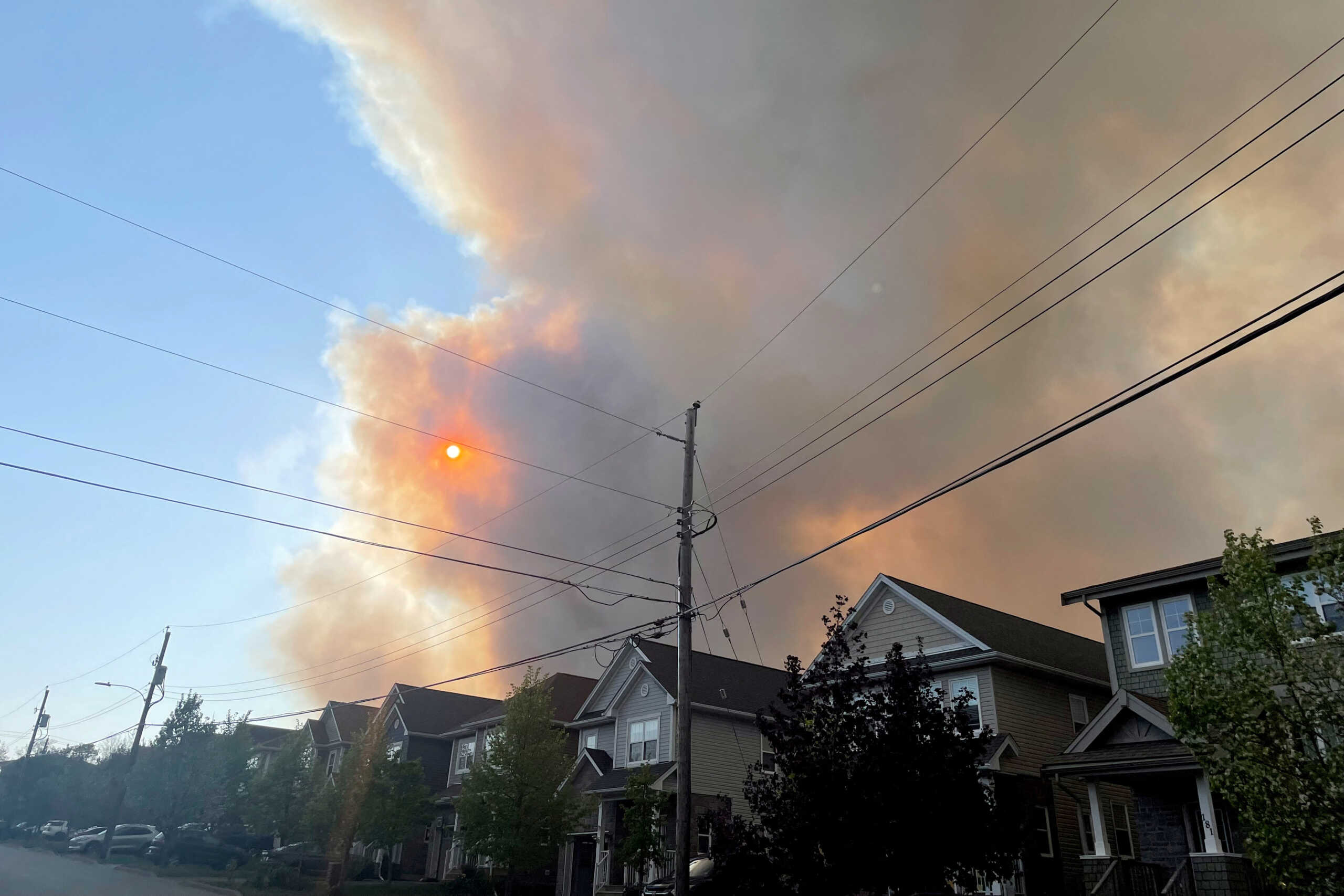 Smoke from the Tantallon wildfire rises over houses in nearby Bedford, Nova Scotia, Canada, May 28, 2023.   REUTERS
