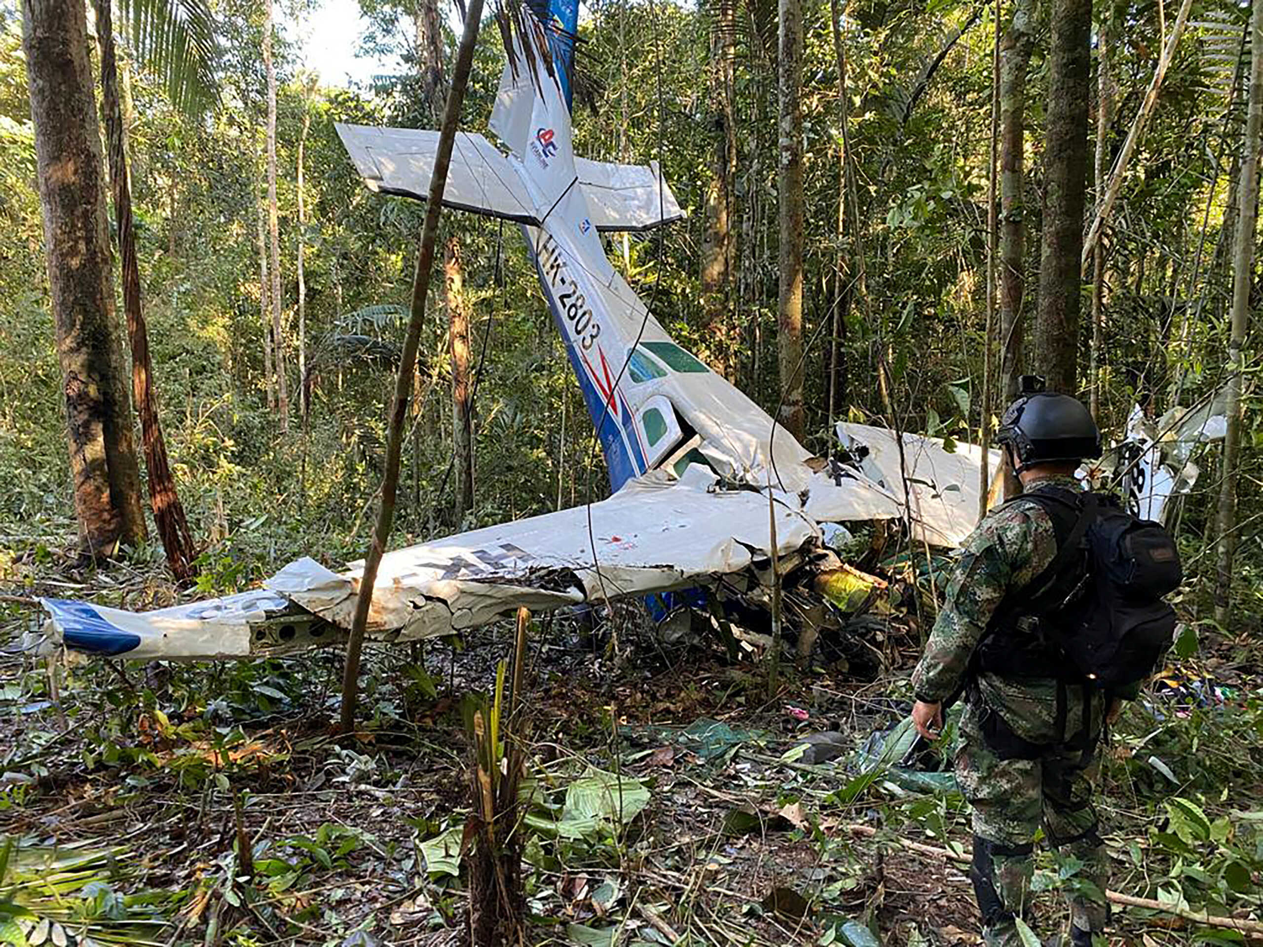 A soldier stands next to the wreckage of a plane during the search for child survivors from a Cessna 206 plane that crashed in the jungle more than two weeks ago in the jungles of Caqueta, Colombia May 19, 2023. Colombian Military Forces