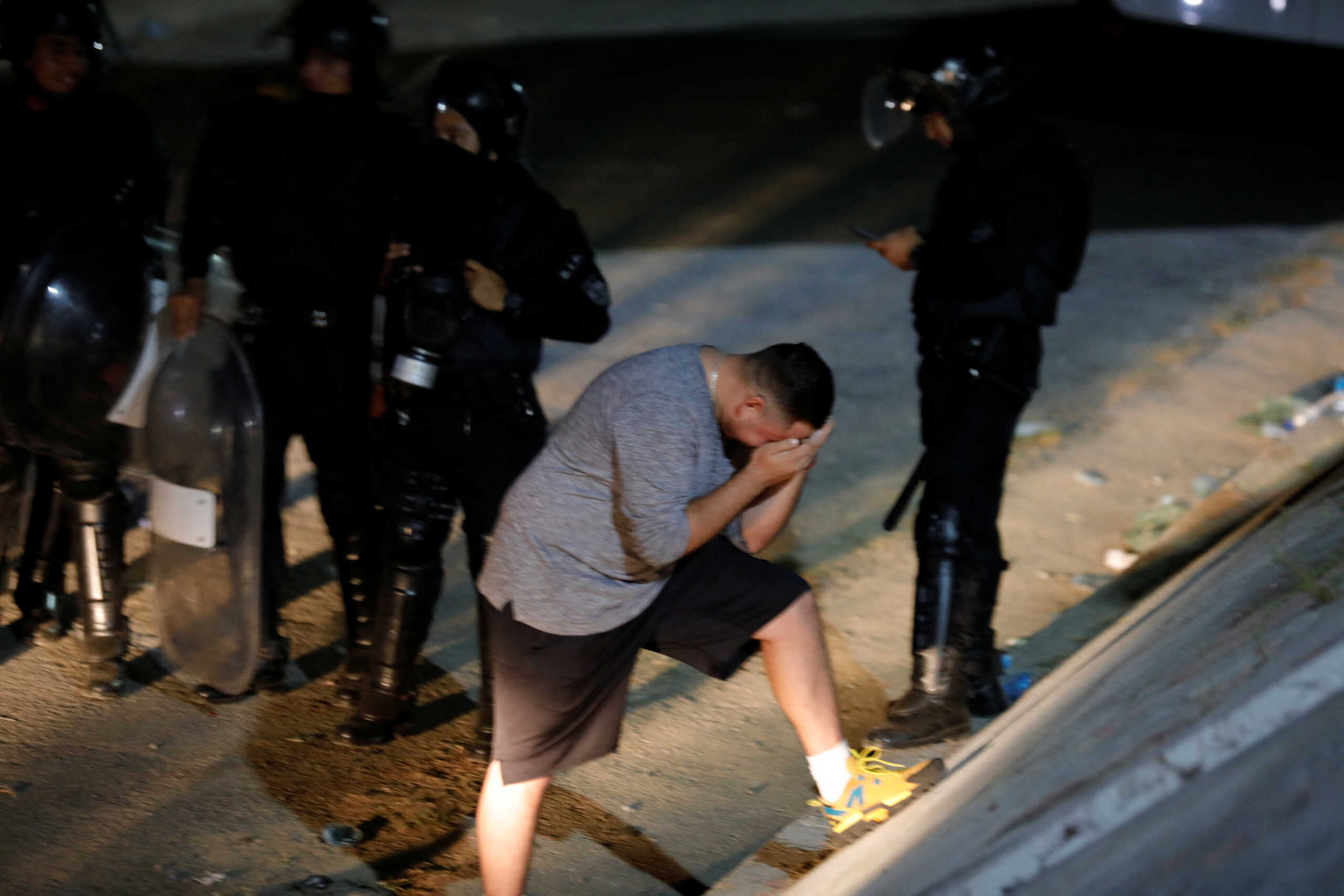 A man reacts outside the Cuzcatlan stadium following a stampede that happened prior to a soccer game between C.D. FAS Vs. Alianza F.C., in San Salvador, El Salvador May 20, 2023. REUTERS