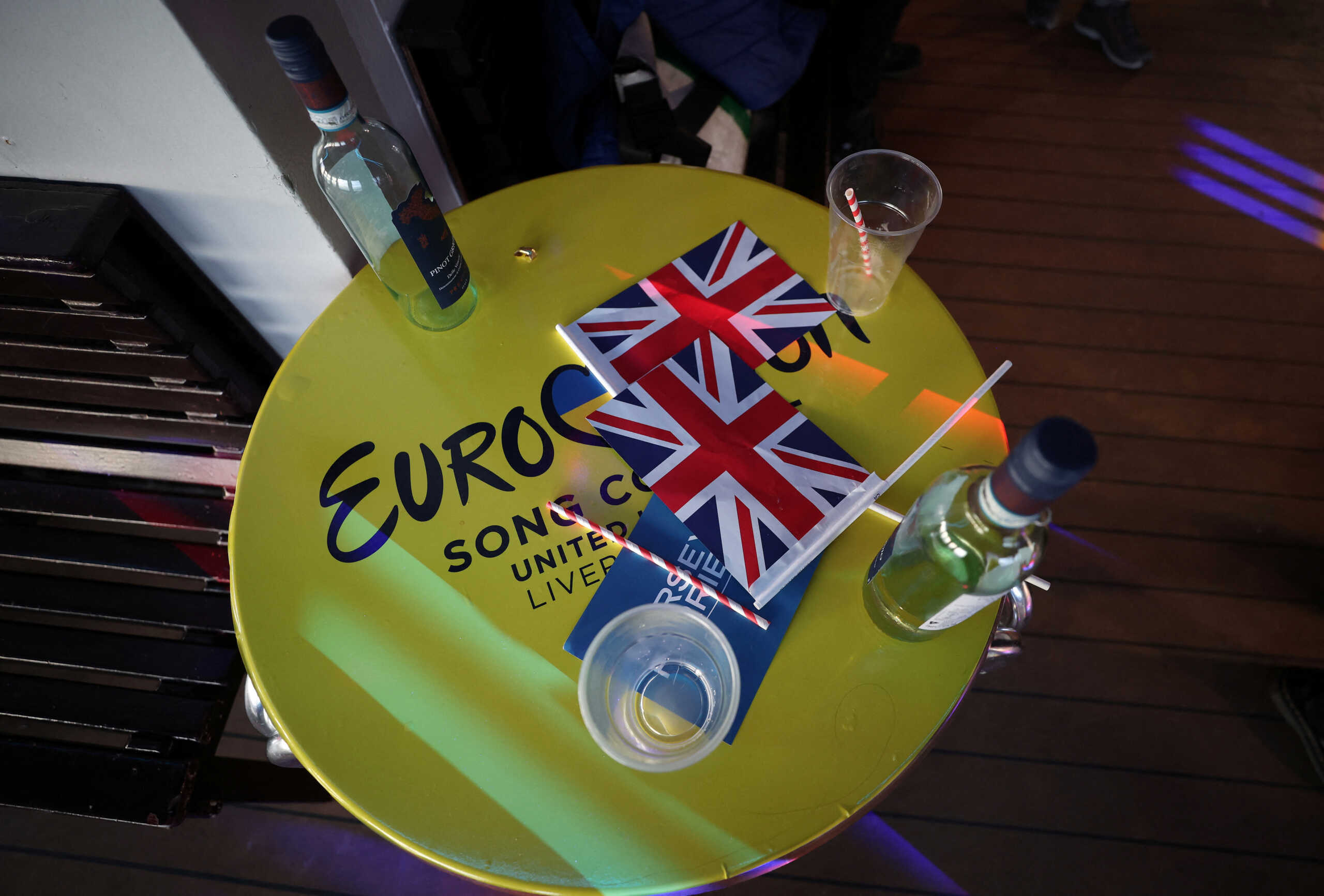 Union Jack flags and empty wine bottles cover a table on one of the Mersey Ferries during a Eurovision party cruise as part of the Eurovision celebrations in Liverpool, Britain May 8, 2023. REUTERS
