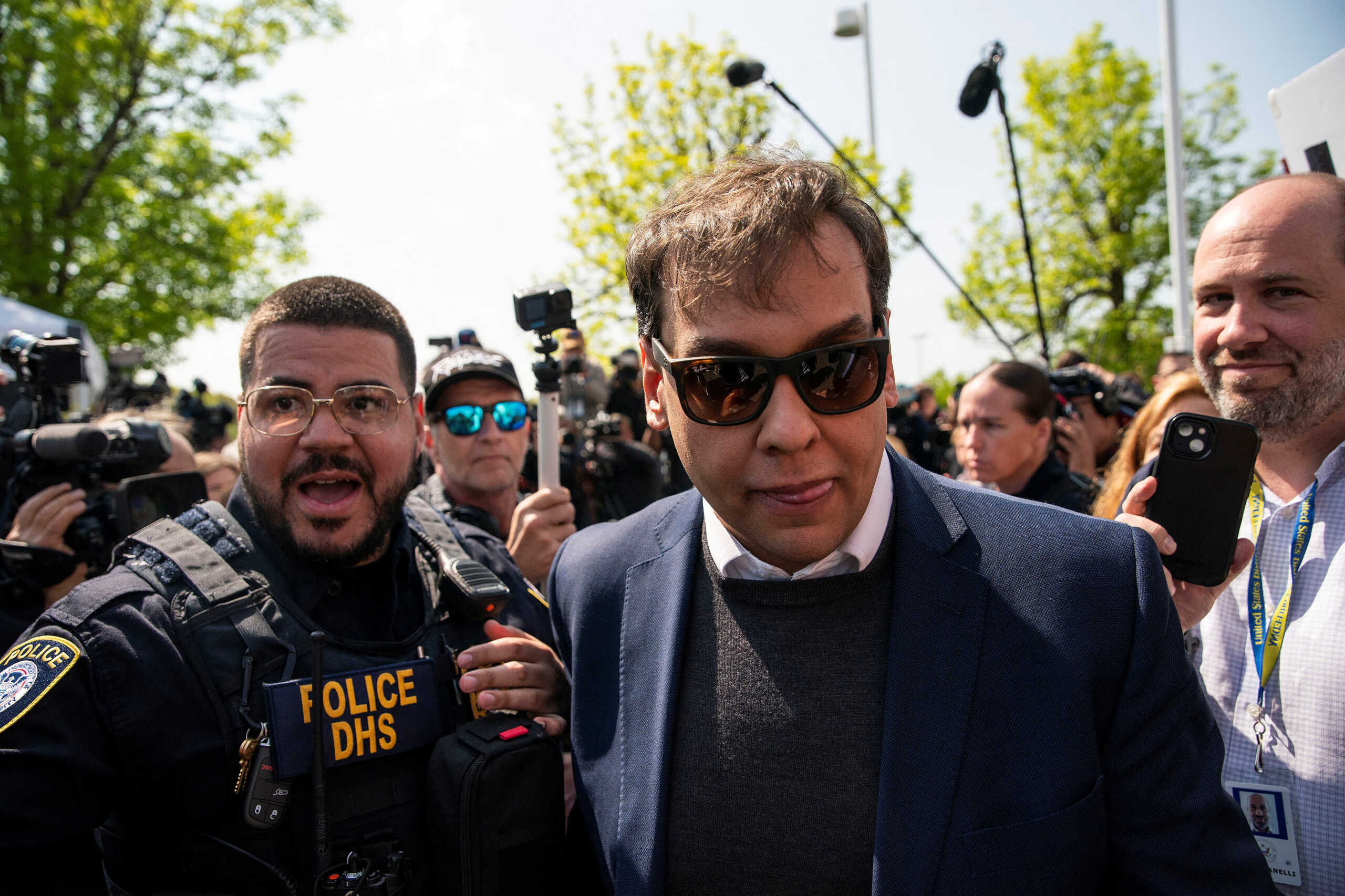 U.S. Representative George Santos (R-NY) is escorted by police as he leaves Central Islip Federal Courthouse in Central Islip, New York, U.S., May 10, 2023. REUTERS