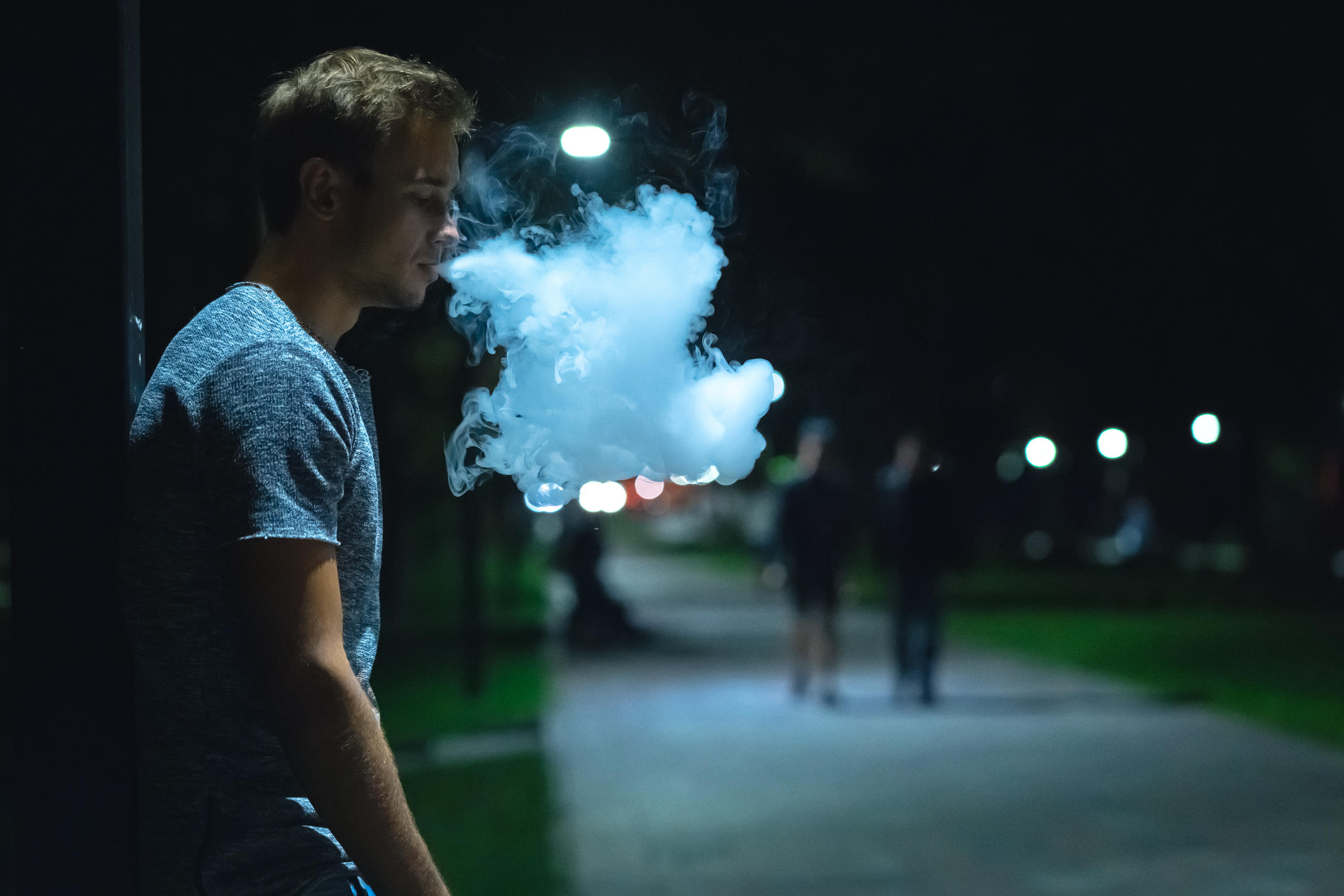 The man smoking on the night street background