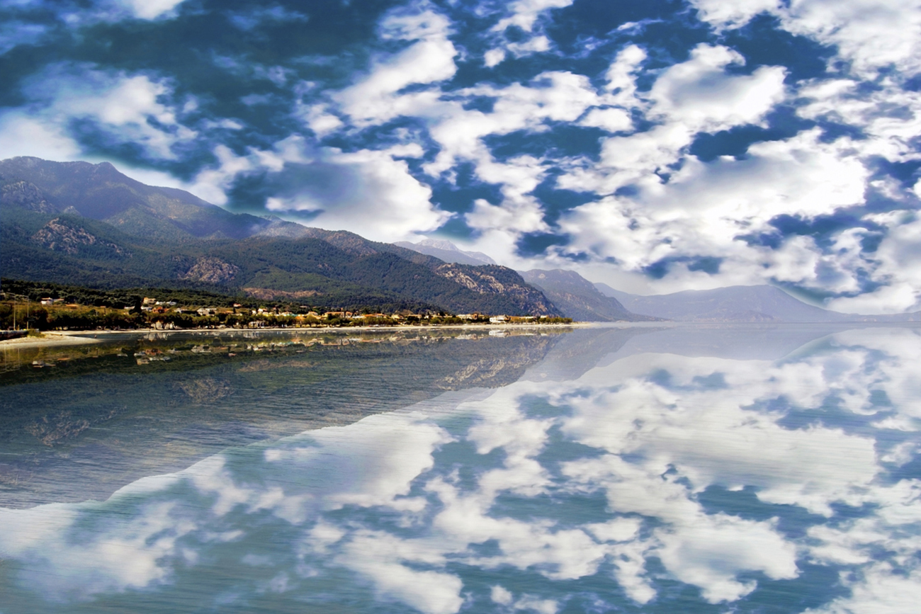 landscape of Alepochori in Greece - mountain and sky reflections on sea - greek summer destination