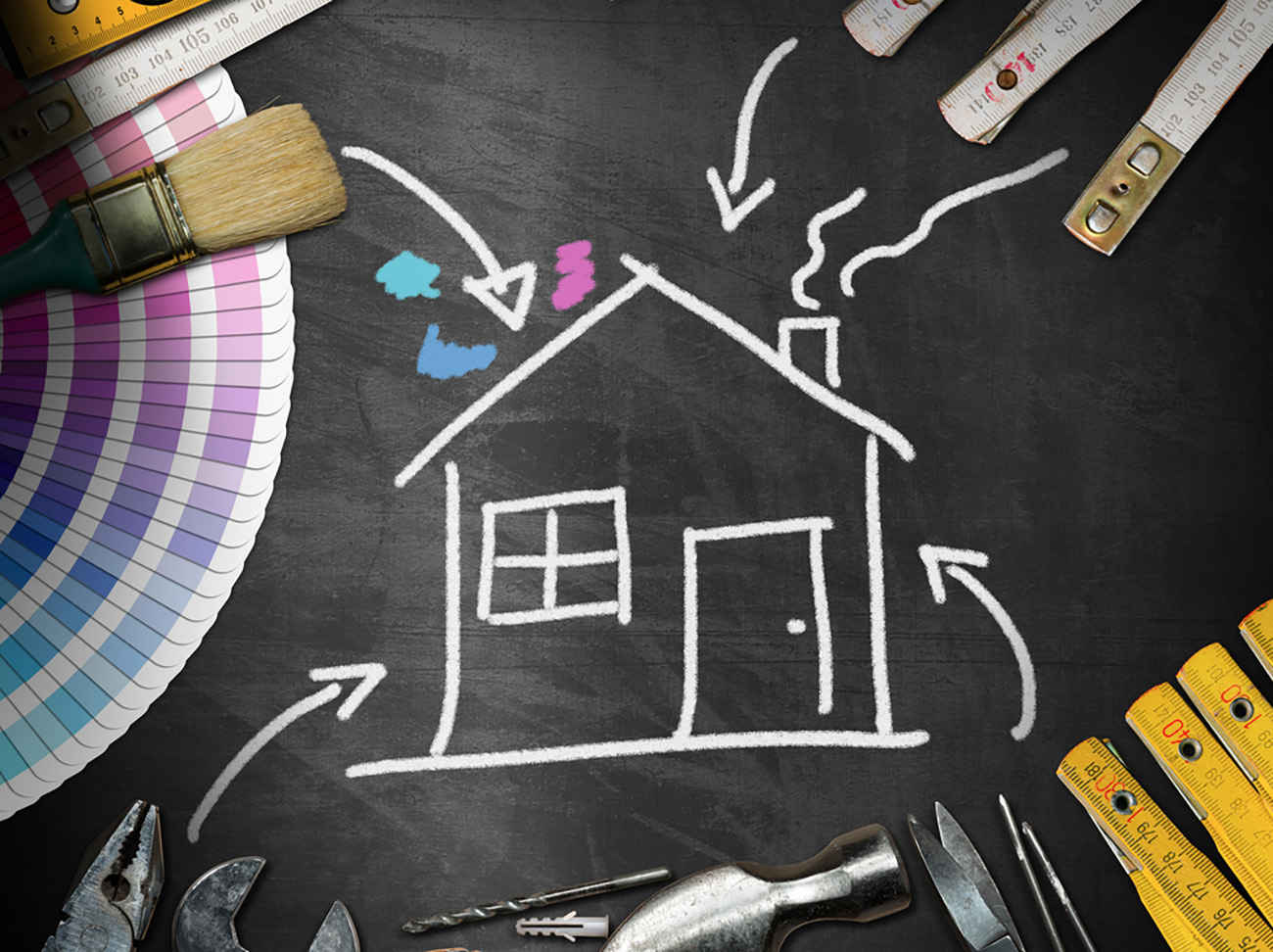 Home improvement concept - Black chalkboard with work tools and a chalk drawing of a house
