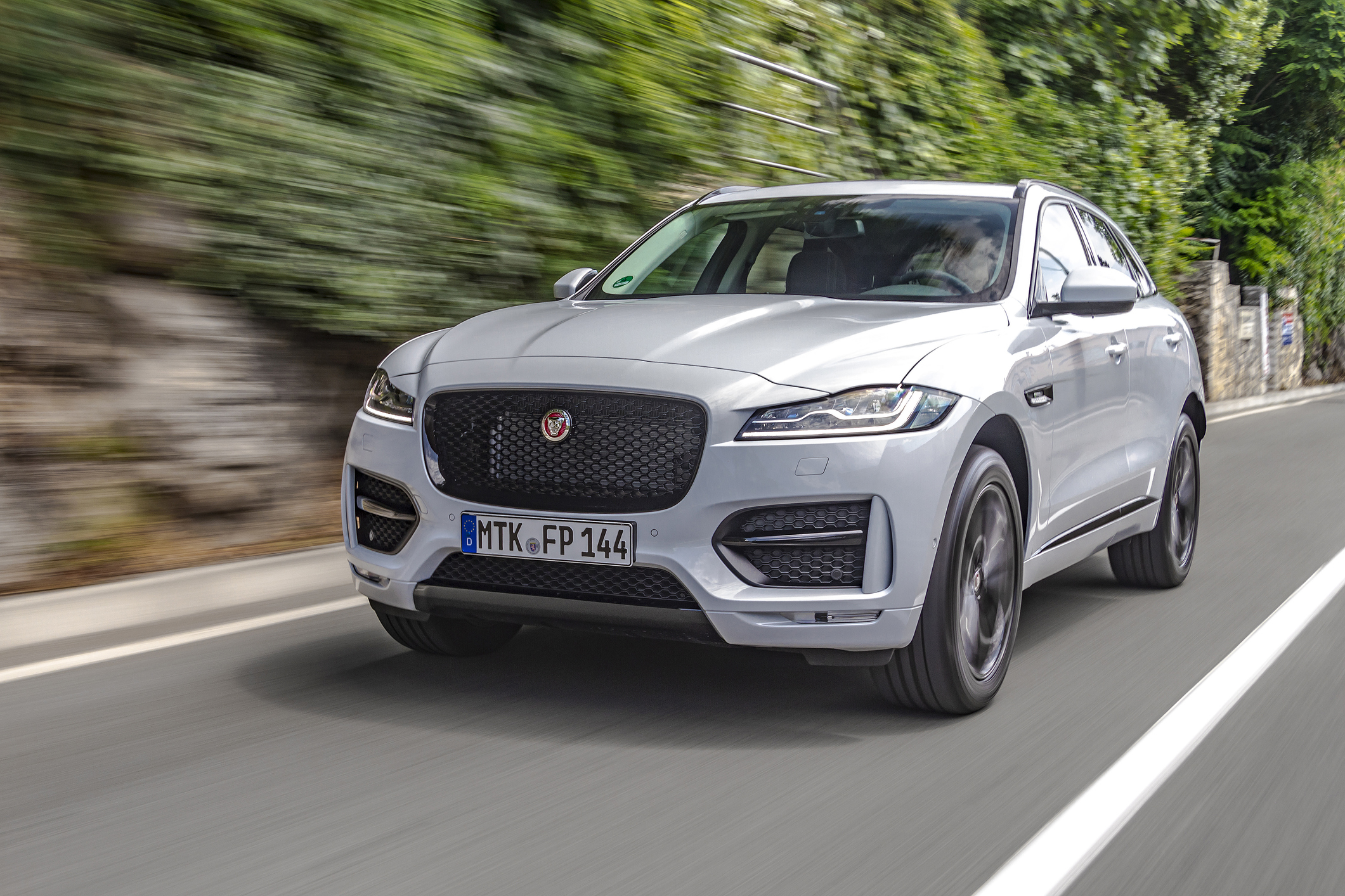 Rijeka, Croatia - July 12, 2016: A man is driving new Jaguar F-Pace fast on a country road. Jaguar F-Pace is the first Sport Utility Vehicle (SUV) made by famous British sports brand Jaguar.