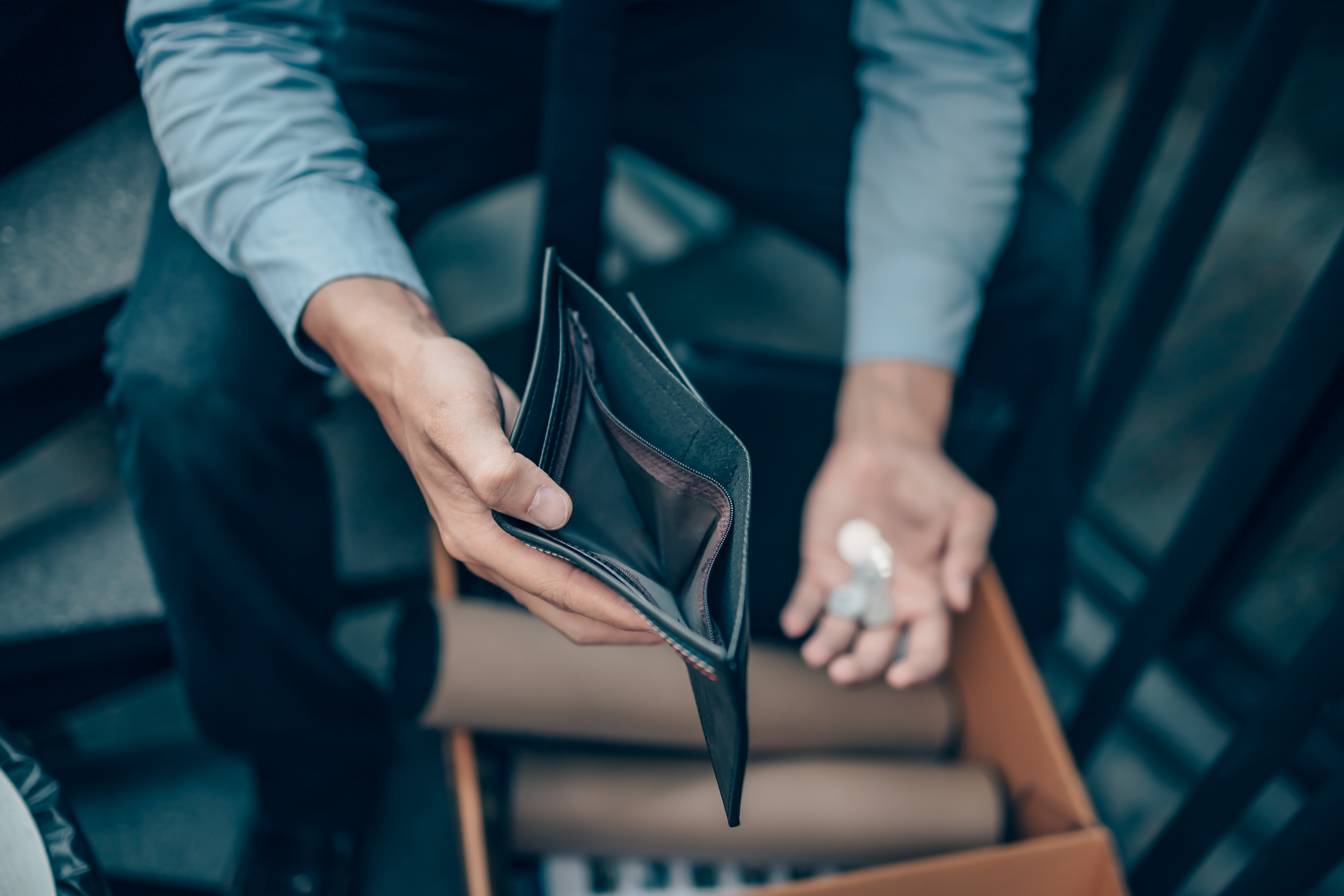 Office worker lost his job and open a wallet without money. Man empty wallet, man broke concept.