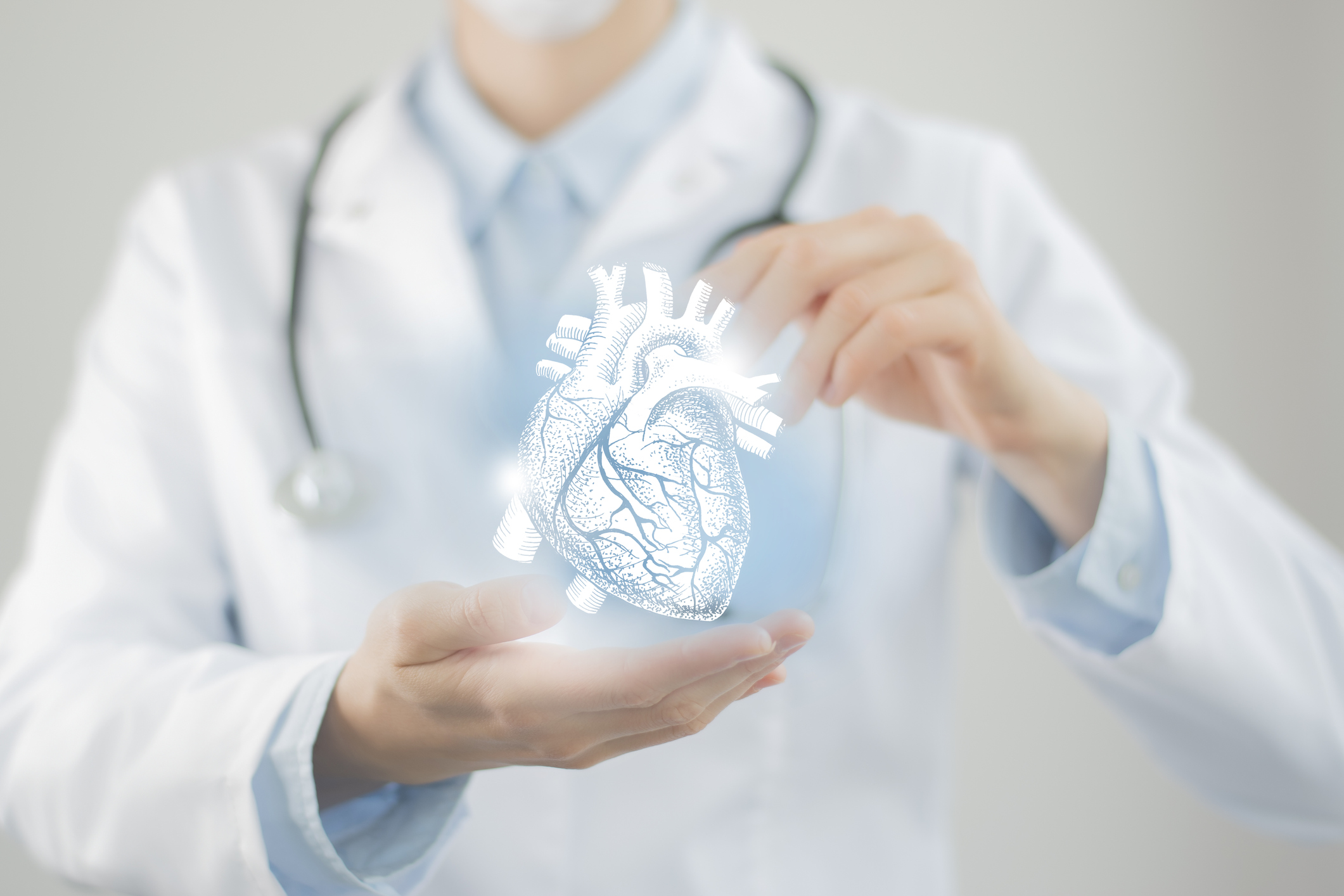 Female doctor holding virtual Heart in hand. Handrawn human organ, blurred figure,  raw photo colors. Healthcare hospital service concept stock photo