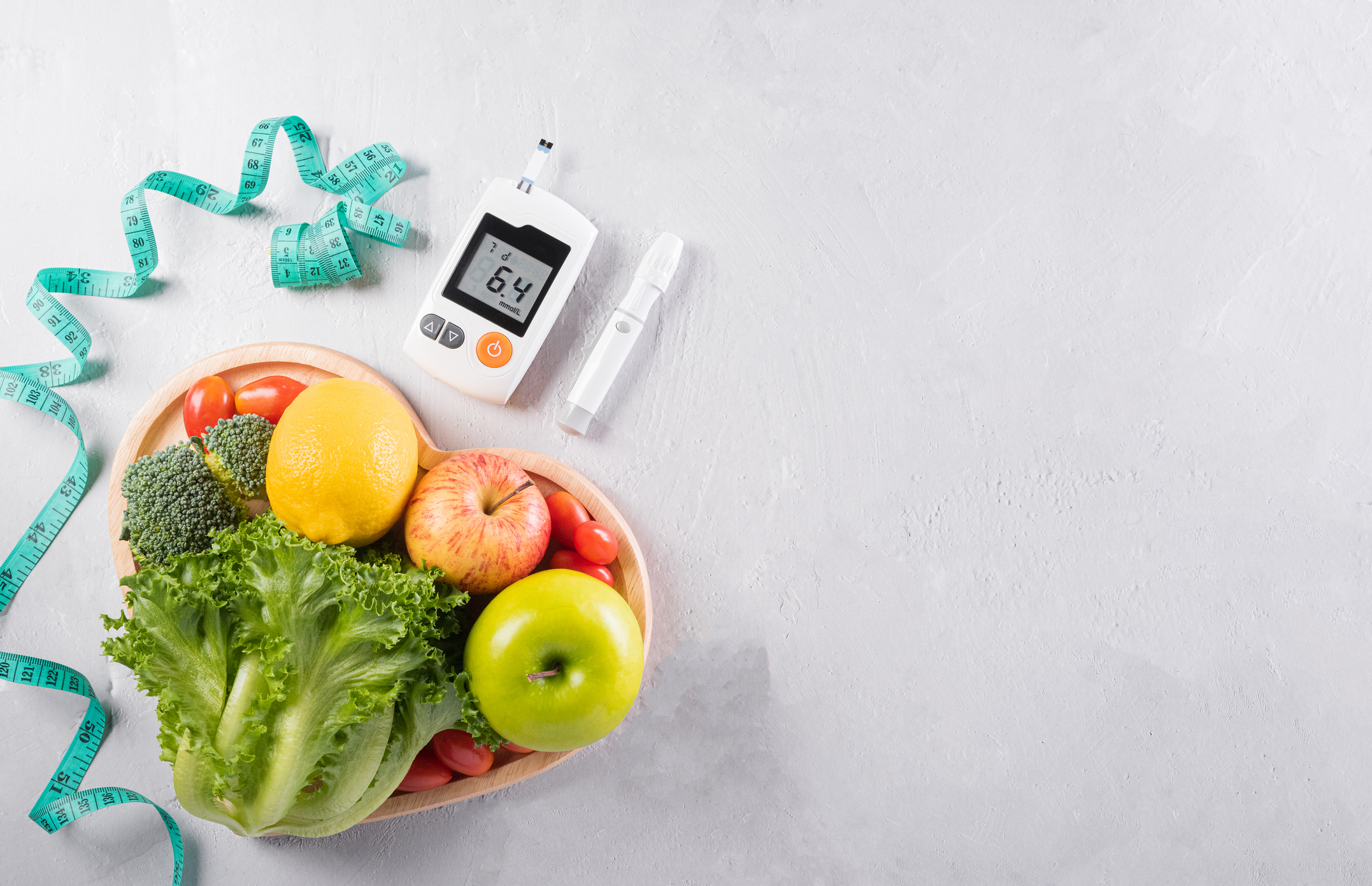 World diabetes day and healthcare concept. Diabetic measurement set, measure tape and healthy food eating nutrition in plate on stone background.