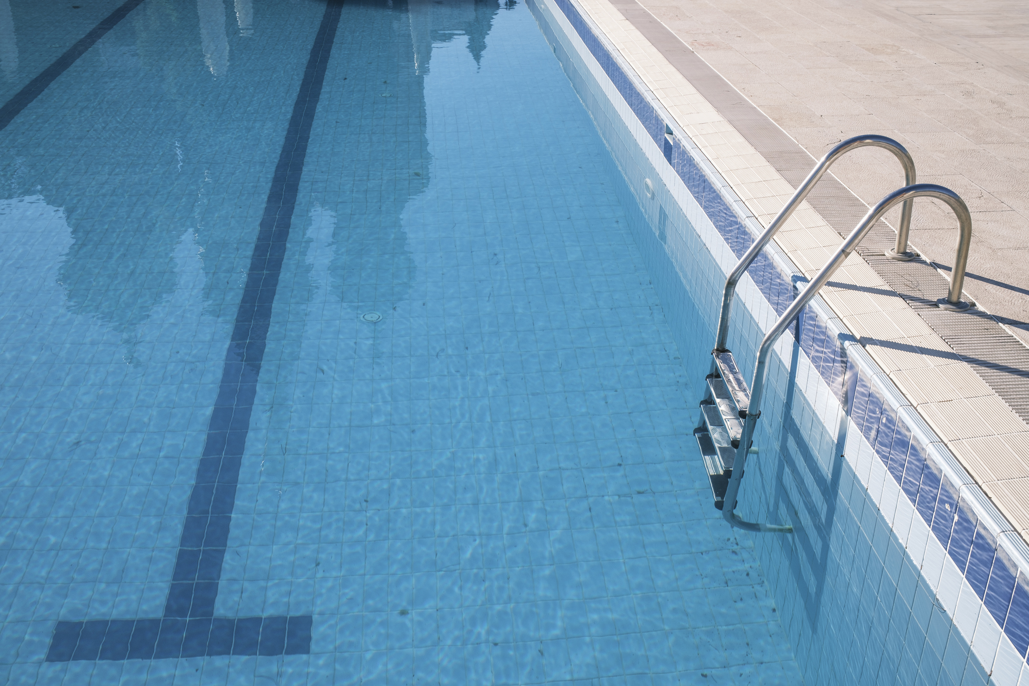 Empty swimming pool view with a steel ladder. Antalya, Turkey.