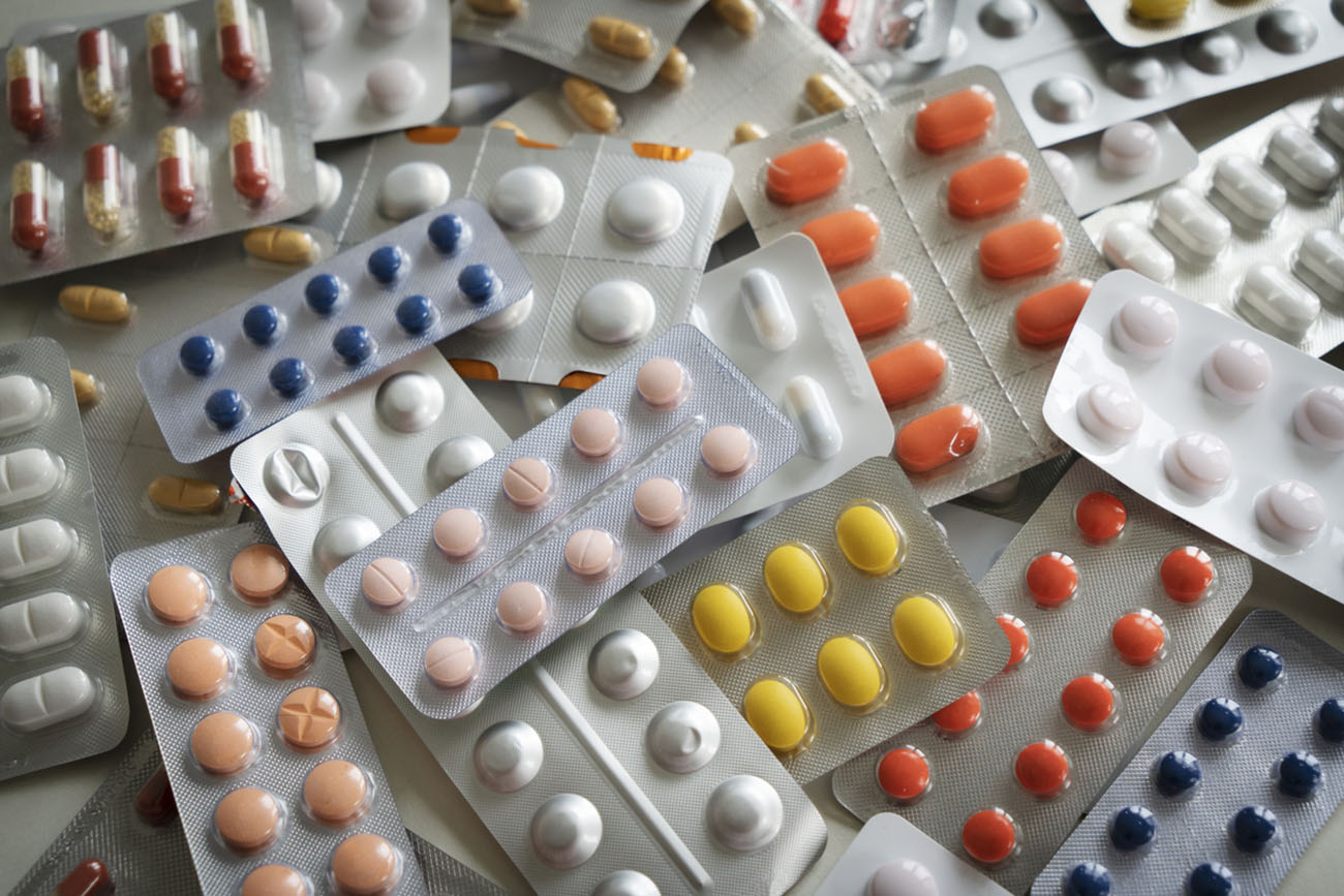 Background of a large group of assorted capsules, pills and blisters
