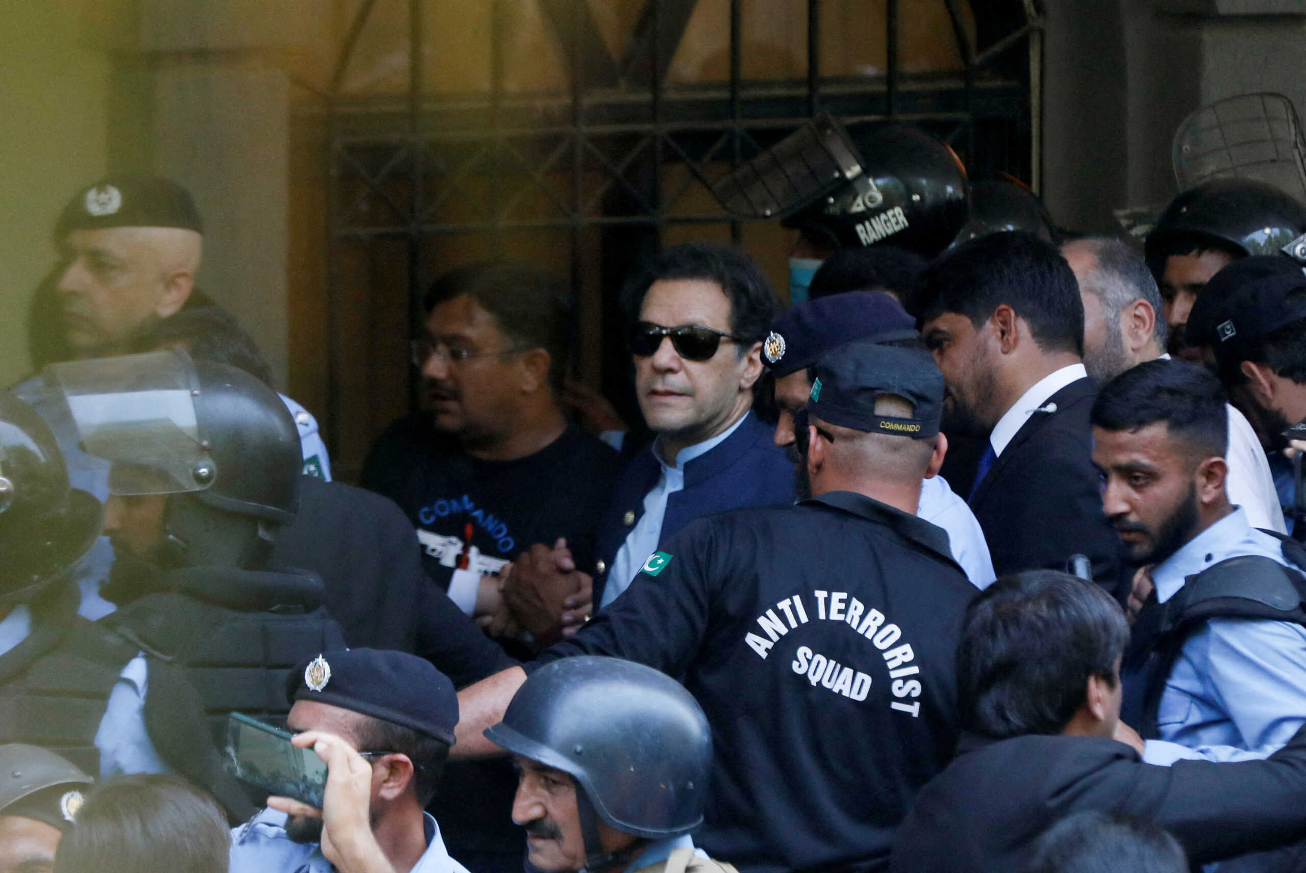 FILE PHOTO: Security officers escort Pakistan's former Prime Minister Imran Khan, as he appeared in Islamabad High Court, Islamabad, Pakistan May 12, 2023. REUTERS