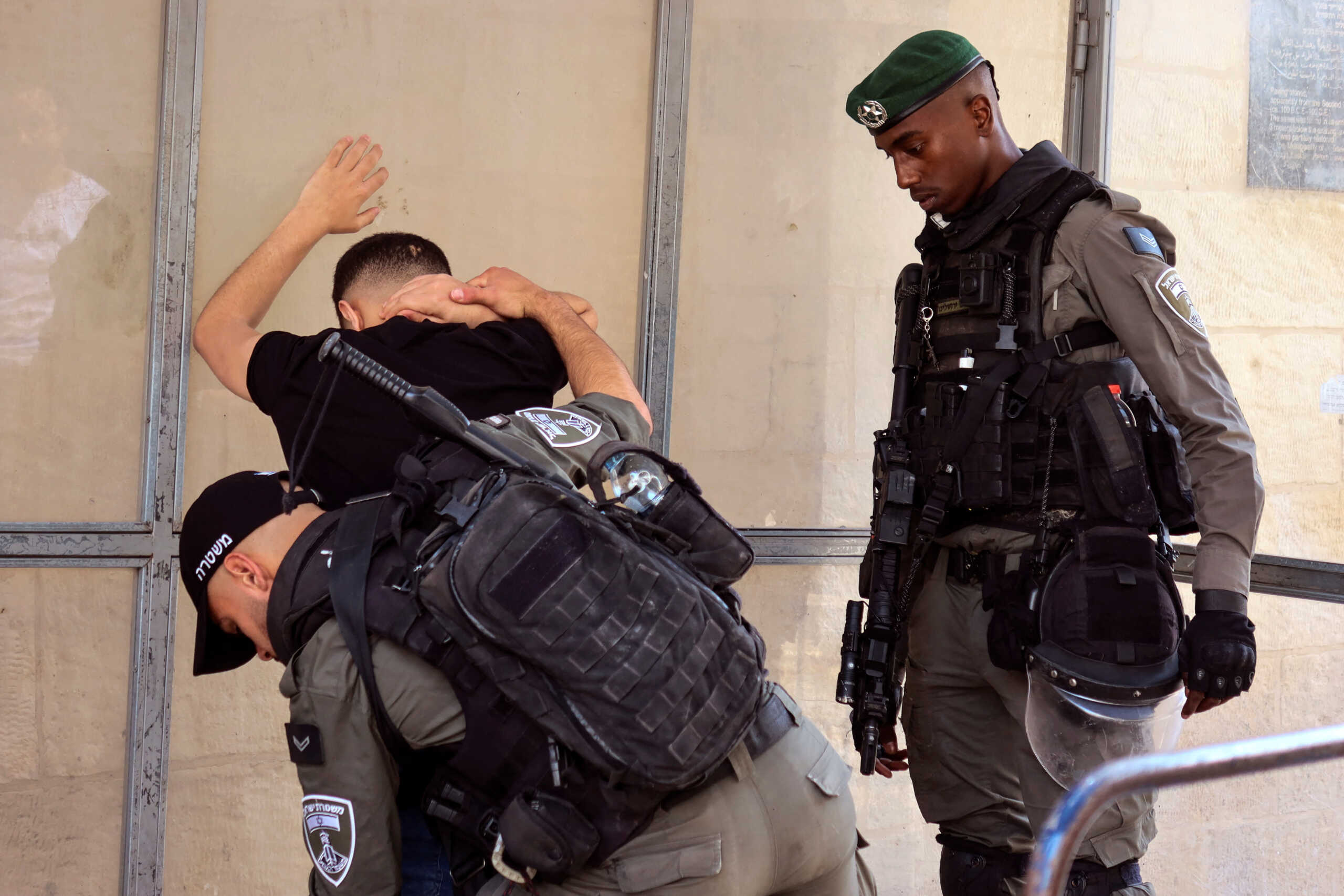 Israeli Border police officers check a Palestinian man in Jerusalem's Old city amid tensions ahead of the annual flag march which marks Jerusalem Day, in Jerusalem May 18, 2023. REUTERS