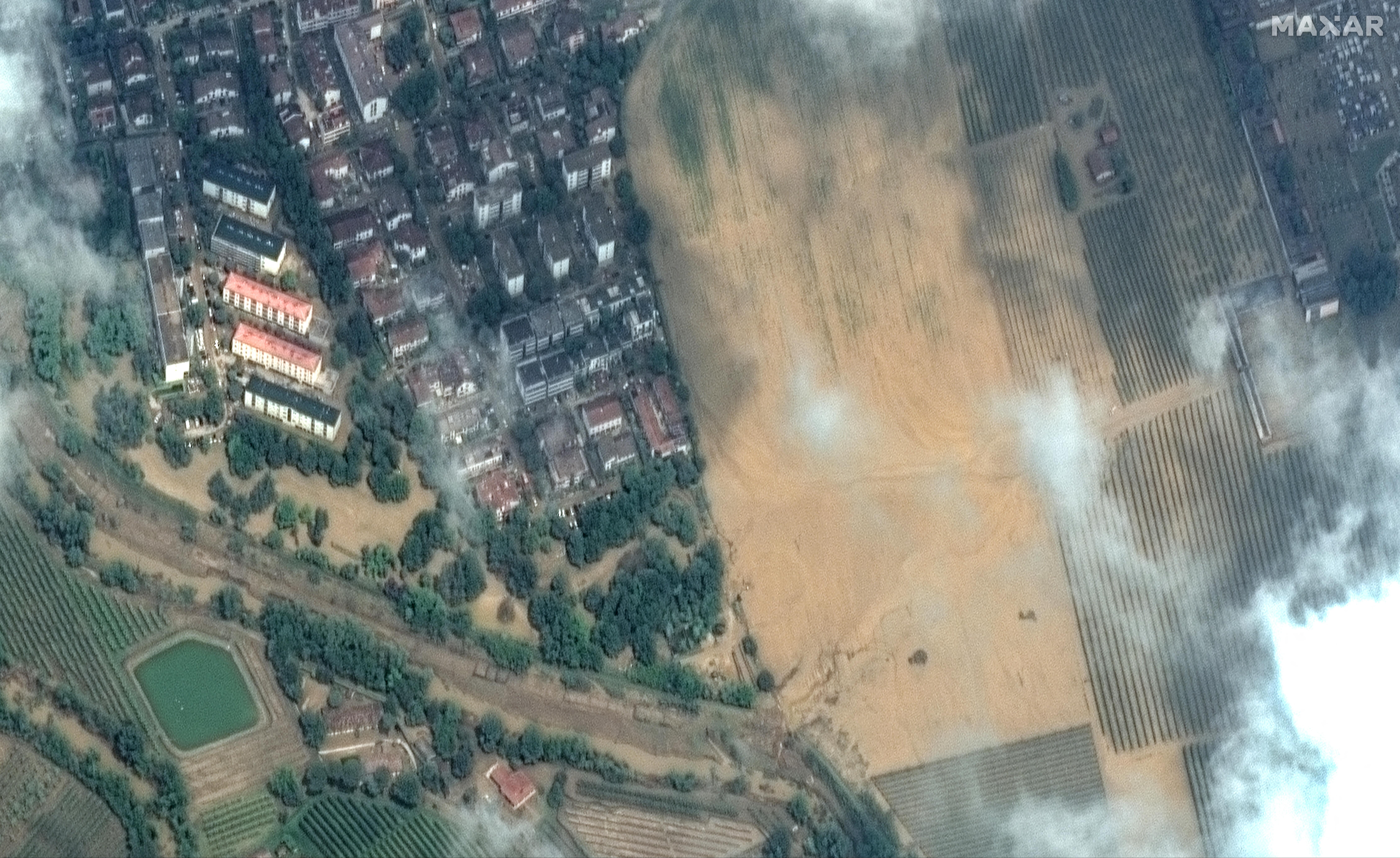 A satellite image shows buildings and flooded fields near the Lamone river in Faenza, Italy May 21, 2023. Maxar Technologies