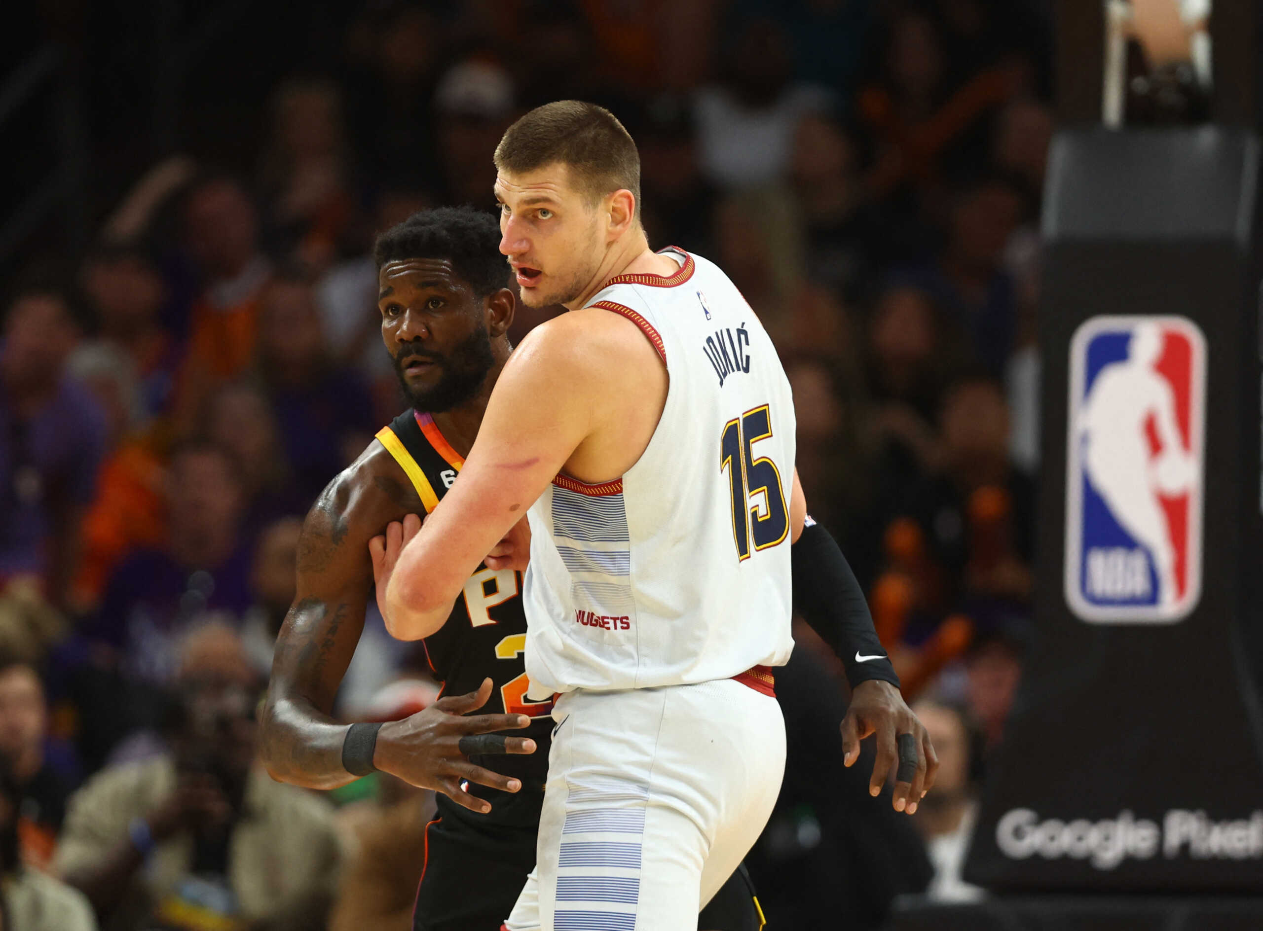 May 5, 2023; Phoenix, Arizona, USA; Denver Nuggets center Nikola Jokic (15) against Phoenix Suns center Deandre Ayton (22) in the first half during game three of the 2023 NBA playoffs at Footprint Center. Mandatory Credit: Mark J. Rebilas-USA TODAY Sports