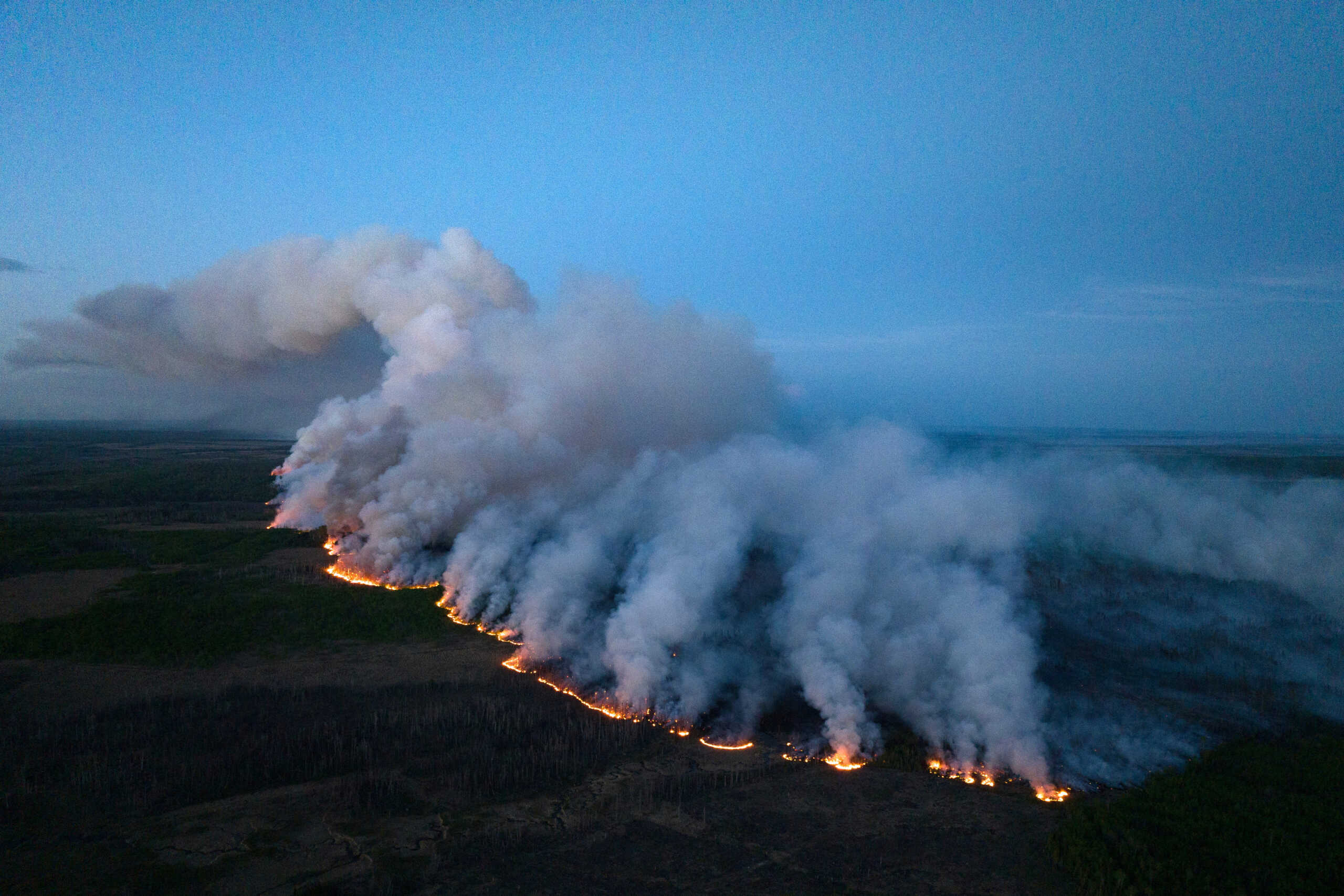 Smoke rises from the Stoddart Creek wildfire near Fort St. John, British Columbia, Canada May 13, 2023.  B.C. Wildfire Service