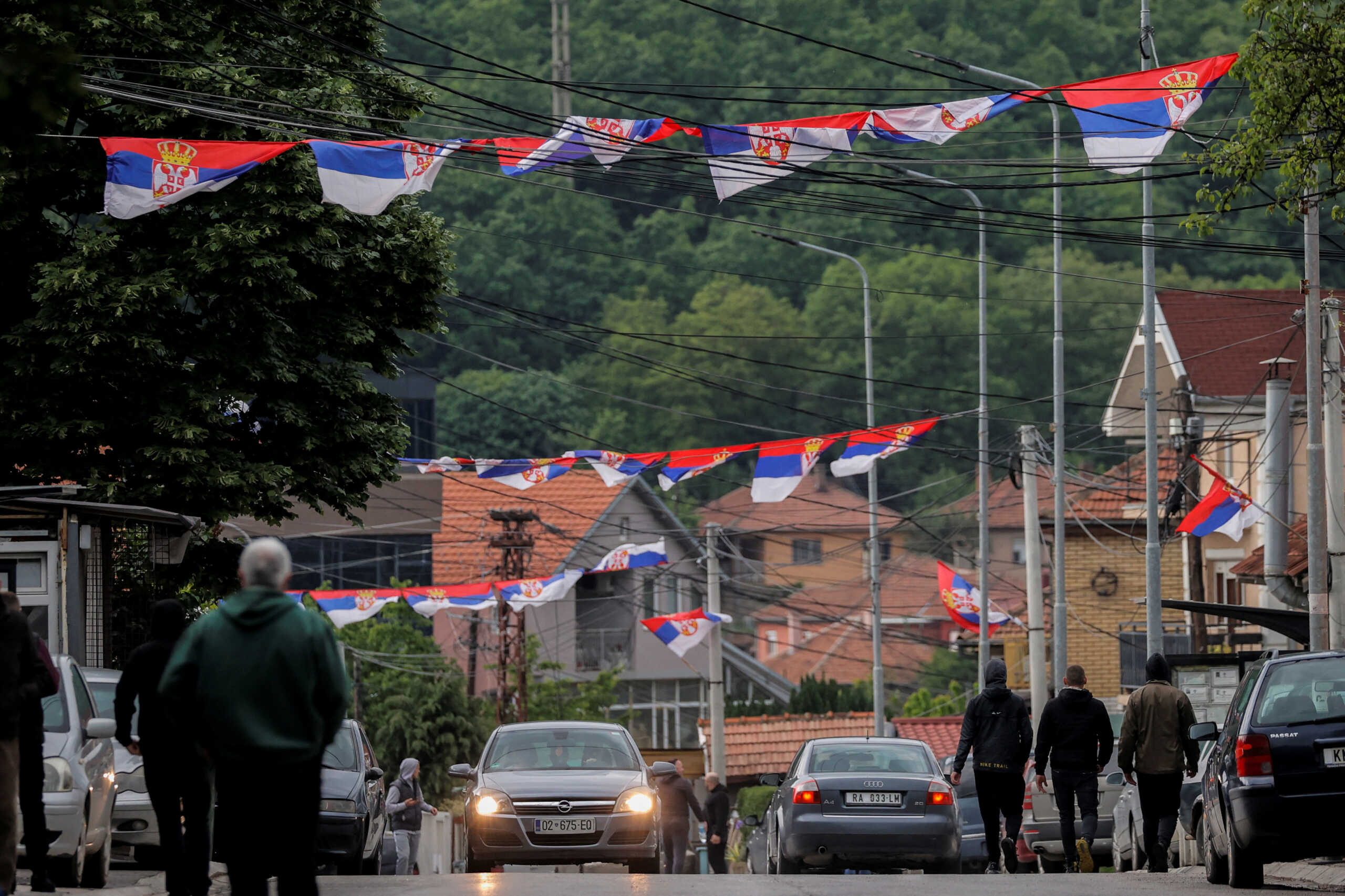 Serbian national flags wave on a street, following clashes between Kosovo police and ethnic Serb protesters, who tried to prevent a newly-elected ethnic Albanian mayor from entering his office, in the town of Zvecan, Kosovo, May 26, 2023. REUTERS