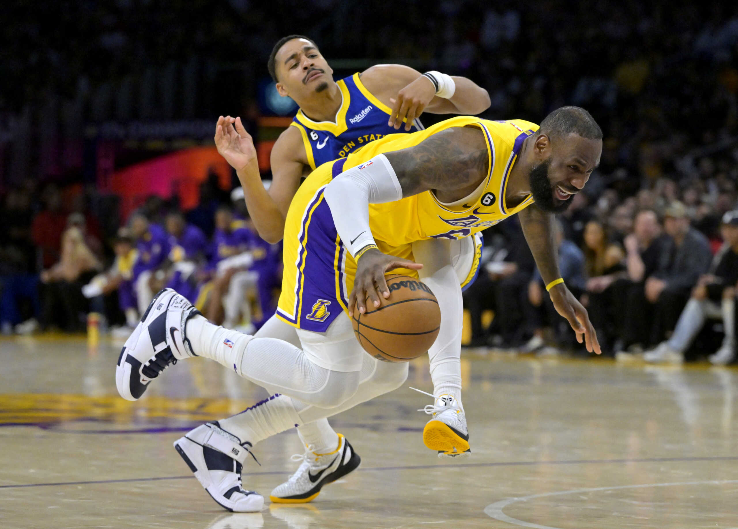 May 12, 2023; Los Angeles, California, USA; Los Angeles Lakers forward LeBron James (6) is tripped up as he is fouled by Golden State Warriors guard Jordan Poole (3) as he drives to the basket in the first half of game six of the 2023 NBA playoffs at Crypto.com Arena. Mandatory Credit: Jayne Kamin-Oncea-USA TODAY Sports